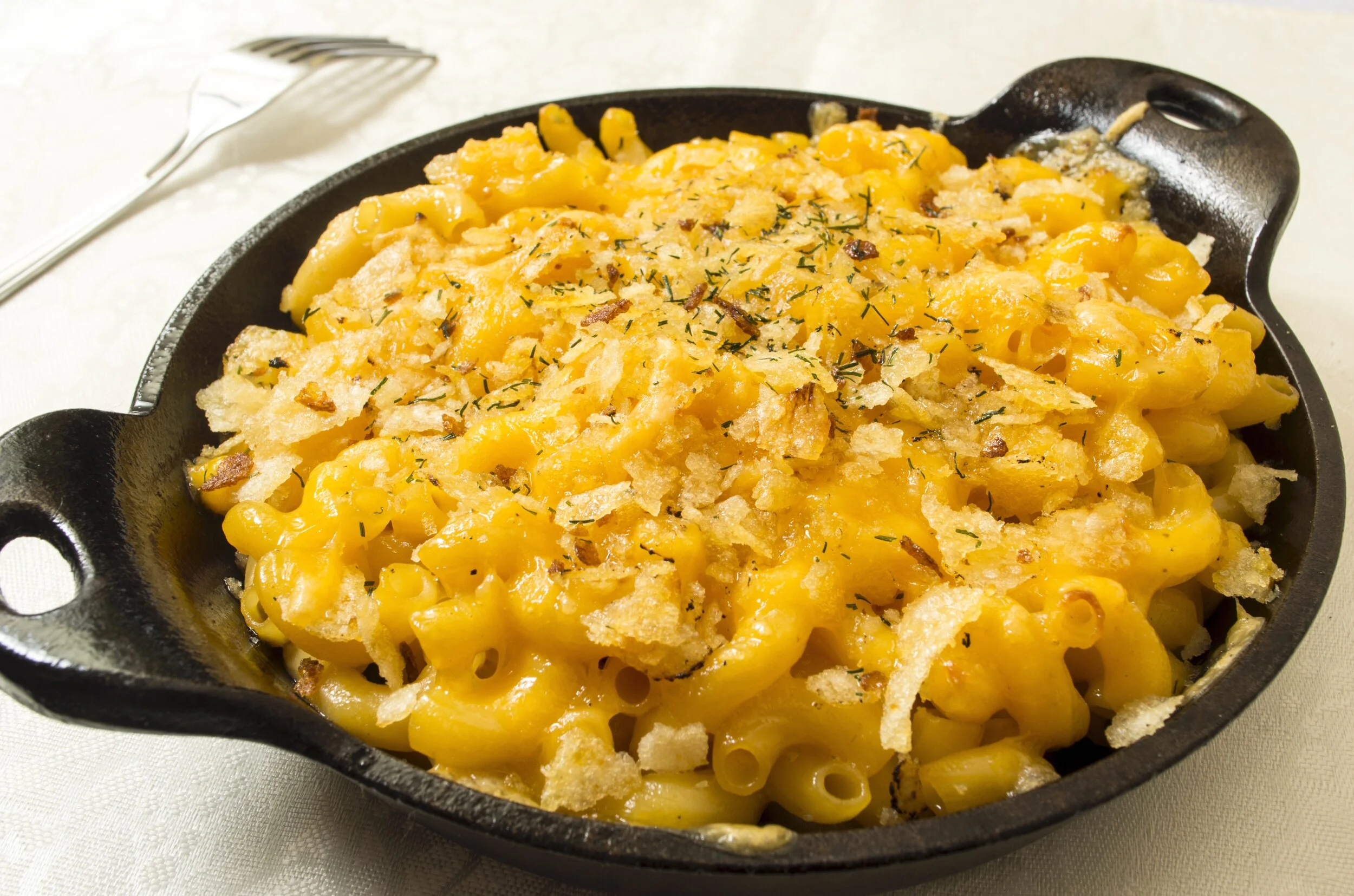 pan of baked macaroni and cheese on white