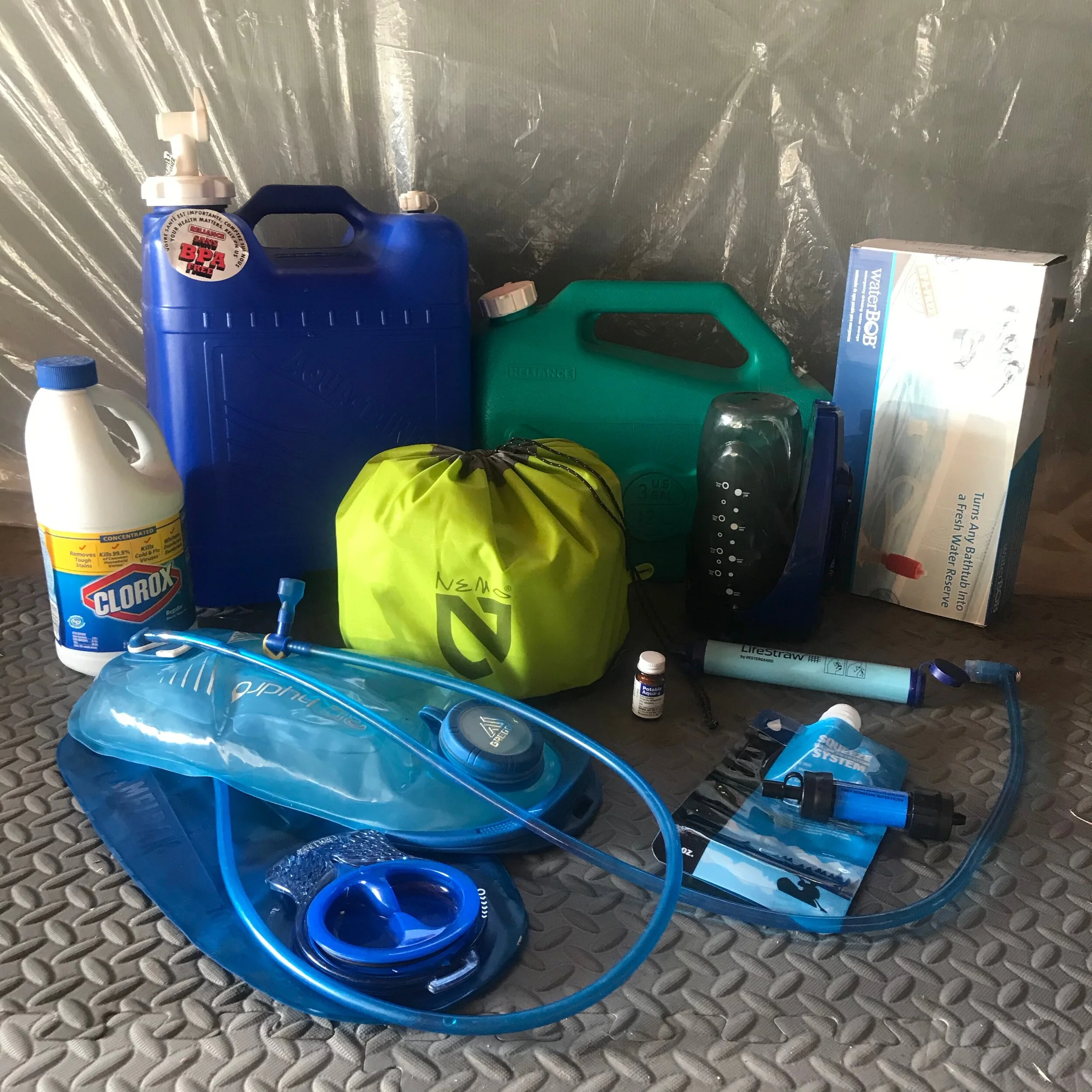 Bleach, 7- and 3-gallon storage containers, bathtub waterBOB, pressure shower, iodine tablets, SteriPen sidewinder, Lifestraw, two 3-gallon water bladders, and a Sawyer Mini