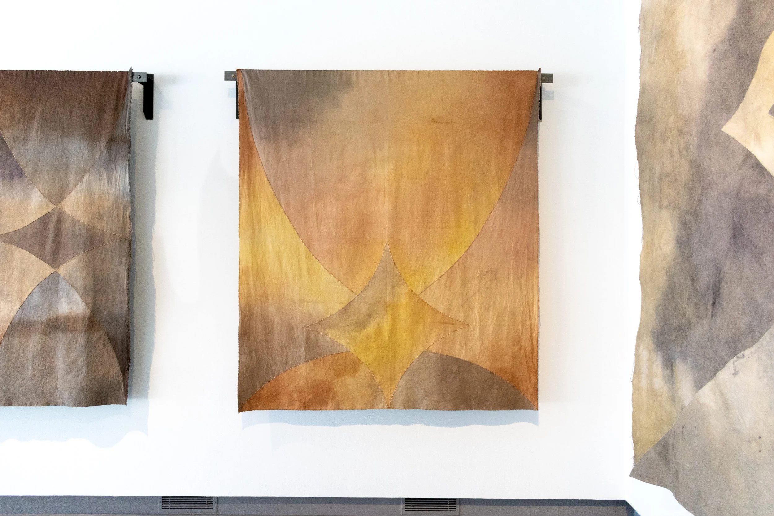   Spring,  Cotton canvas, natural dye (walnut, cutch, avocado pits, weld, modulated with iron), welded steel, metal bar, canvas folded into fours and cut once, folded in half and cut twice, unfolded and rearranged, hand sewn back together with glass 
