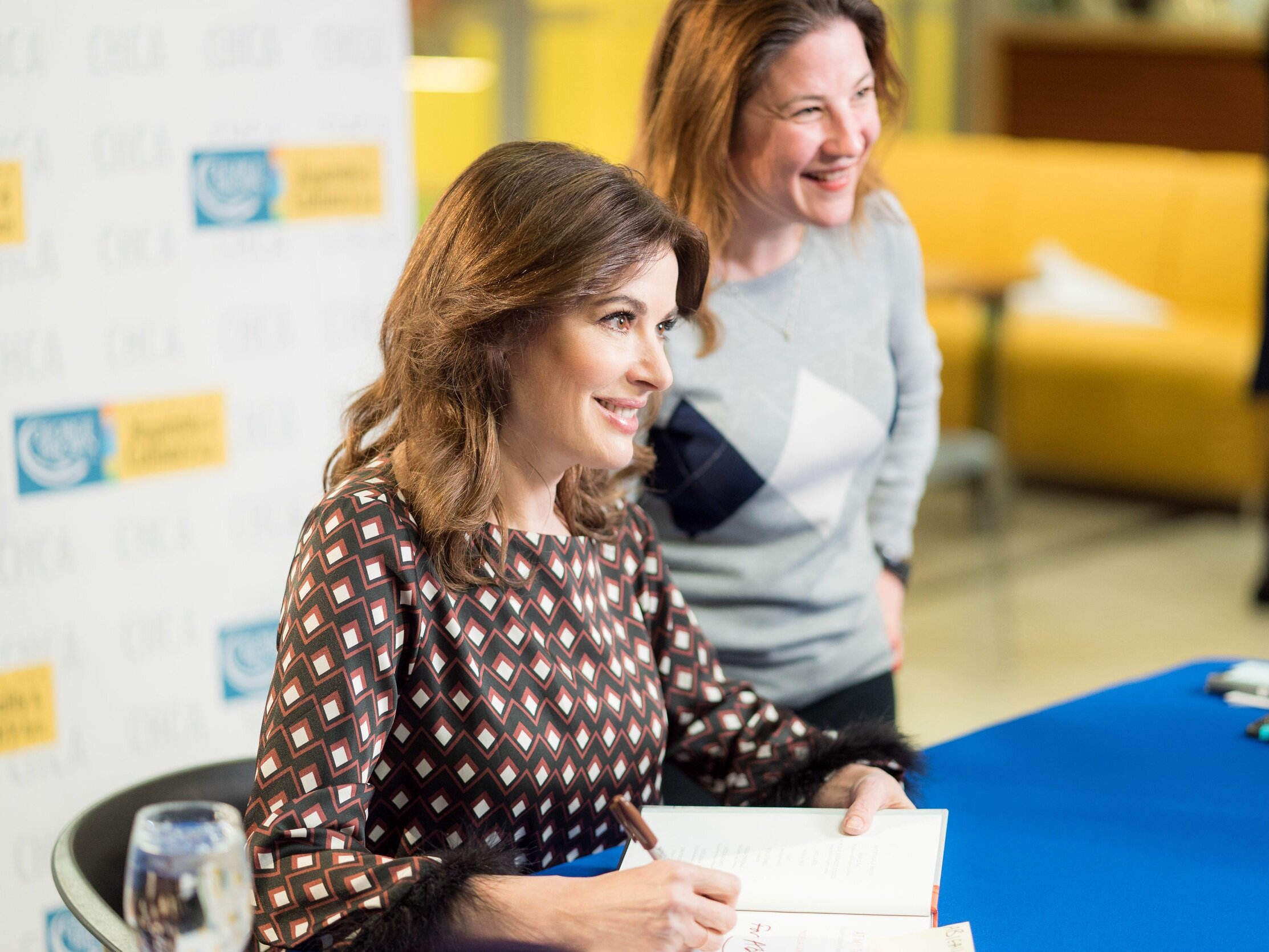 Nigella Lawson signing books with a guest at George Brown College's Centre for Hospitality & Culinary Arts