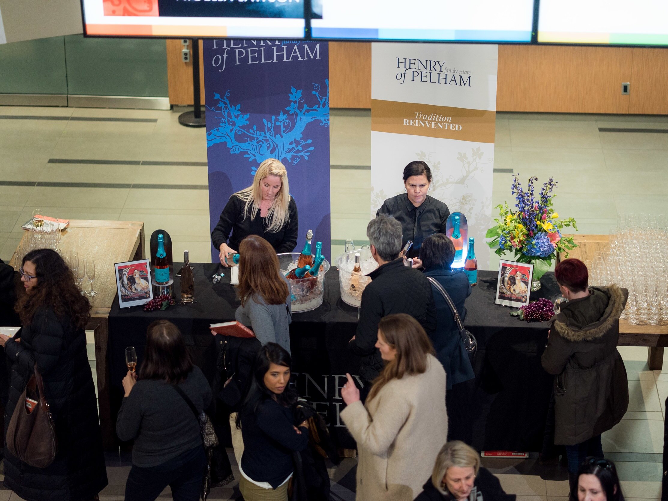 Guests enjoying wine at a food and drink festival marketplace at George Brown College's Centre for Hospitality &amp; Culinary Arts