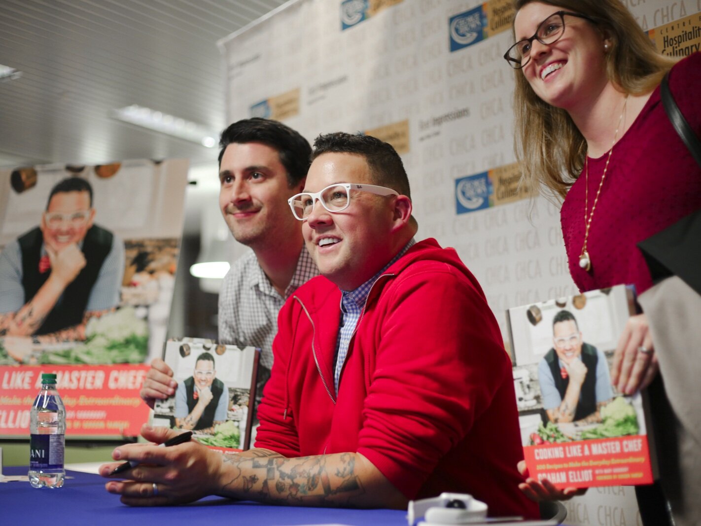 Two MIchelin Star Chef Graham Elliot signing books with guests at George Brown College's Centre for Hospitality & Culinary Arts