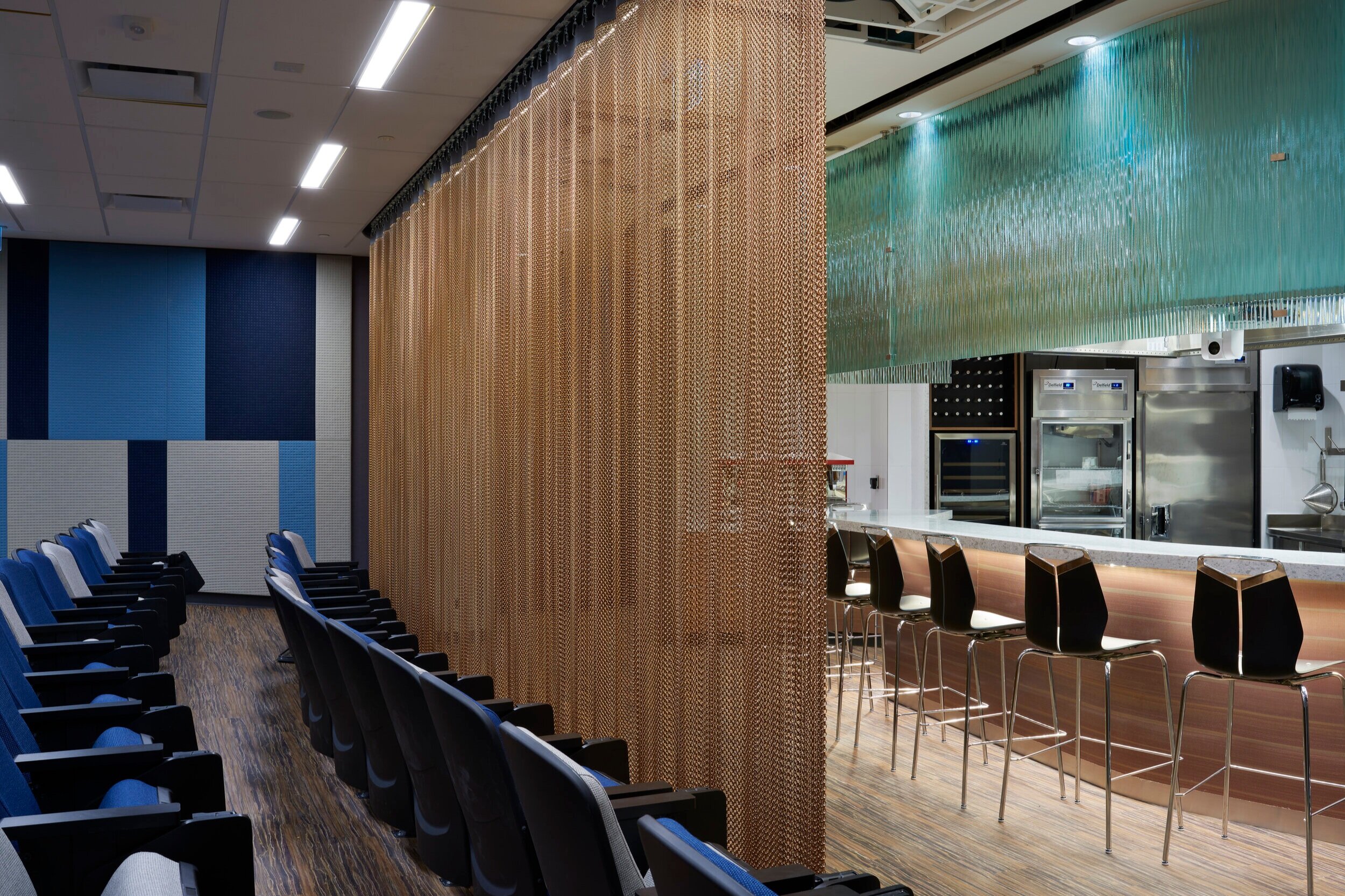Alternate side view of the chef's table with privacy curtain in the Culinary Demonstration Theatre at the Centre for Hospitality &amp; Culinary Arts at George Brown College