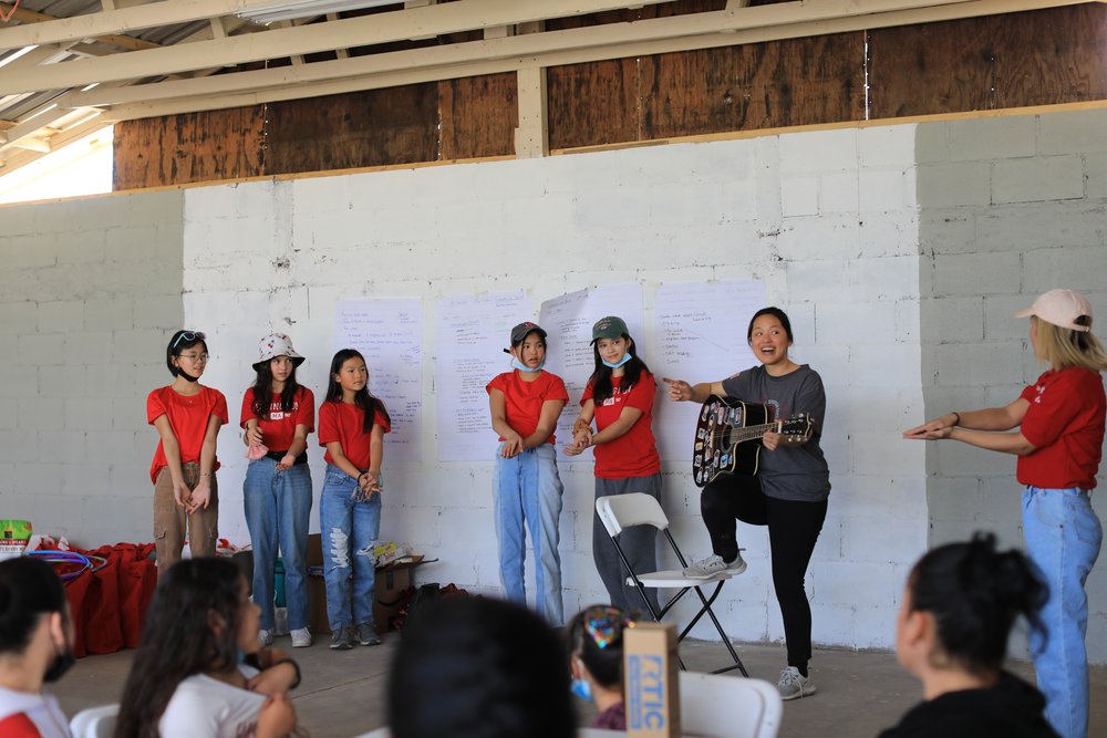 MdC staff Eunice leads families in a song