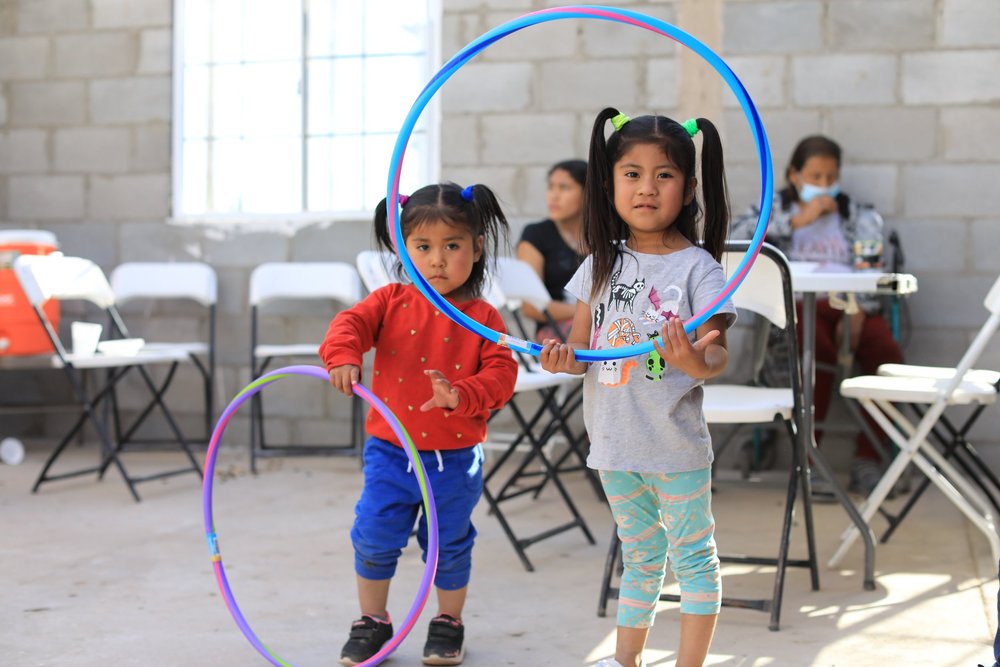 Two children play with hoola hoops