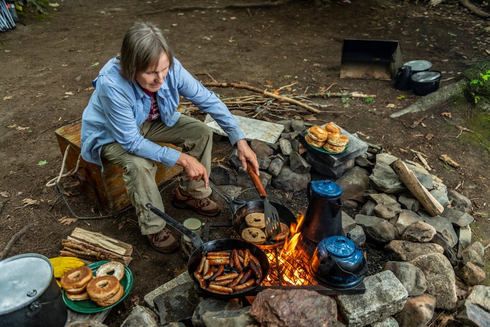 Trip leader Polly Mahoney cooking a meal on the campfire.