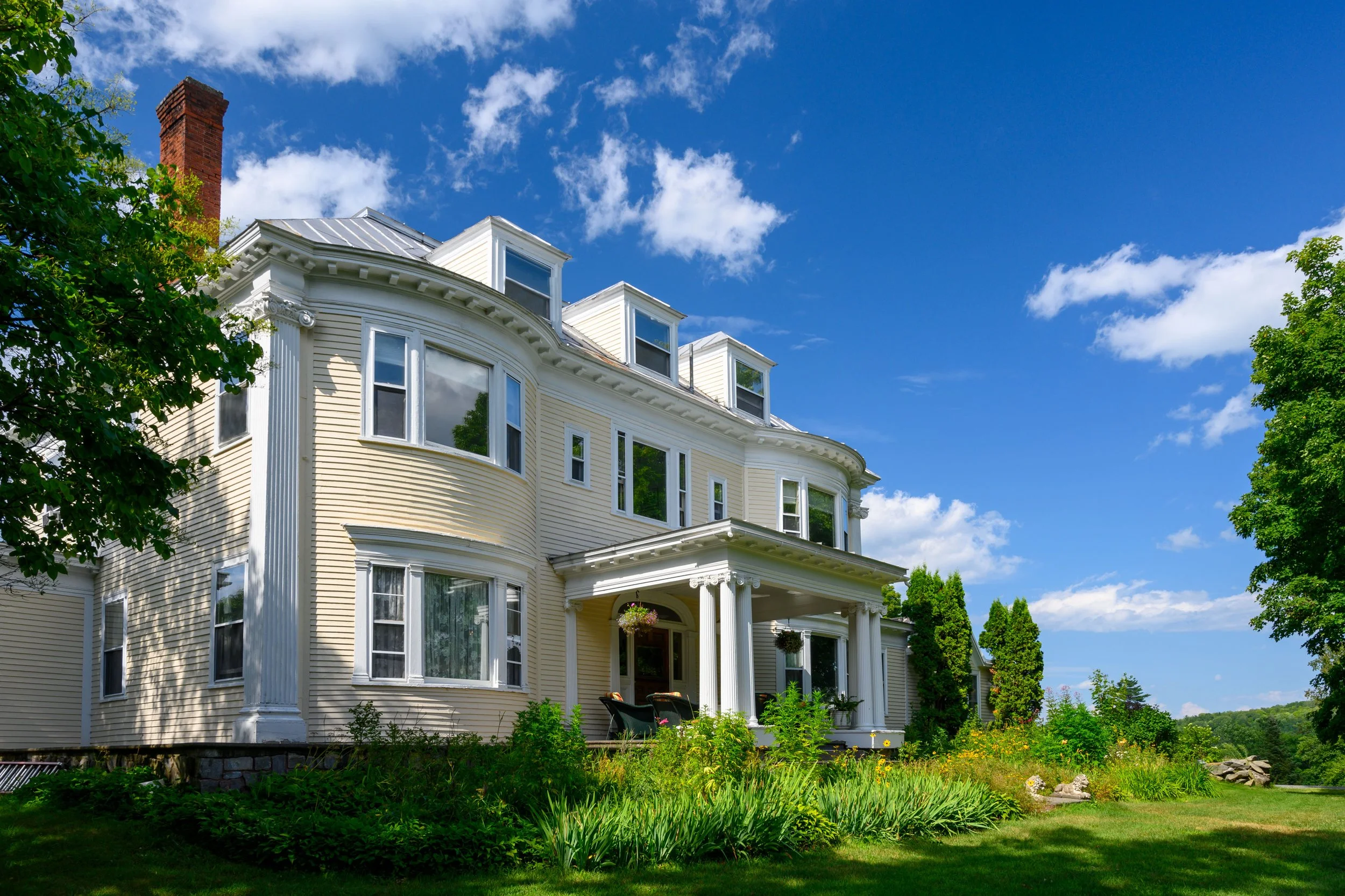 Light yellow mansion on a bright sunny day