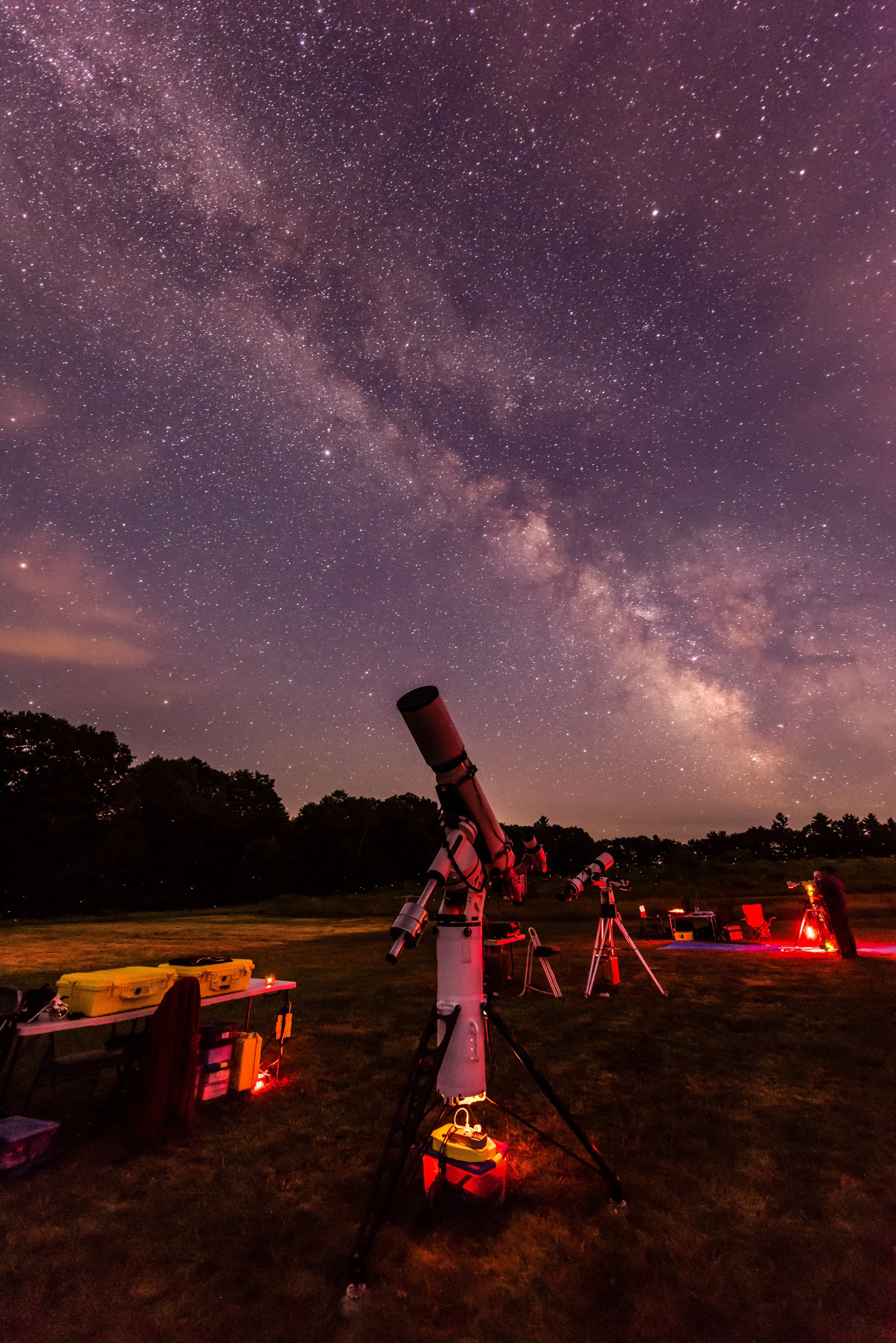 A telescope is aimed at the sky on a starry night