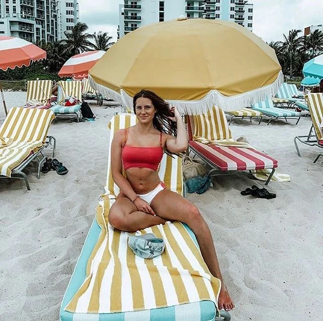 @kaitlin_cora on our yellow ocean stripe towel at the @theconfidante ☀️