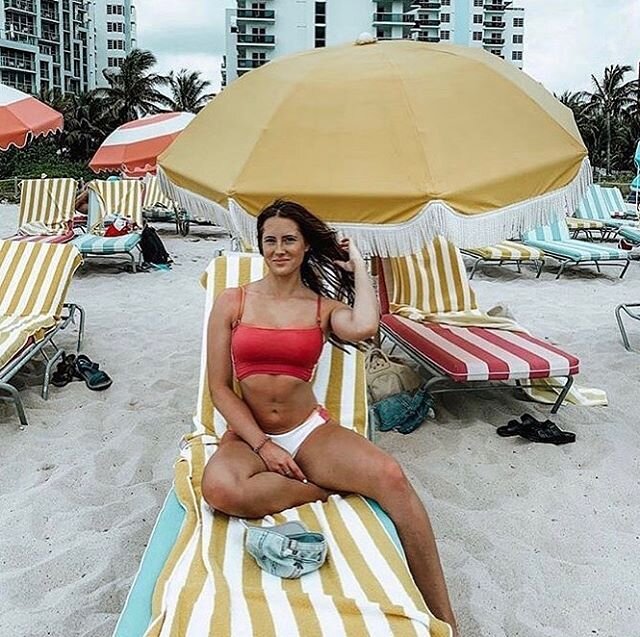 @kaitlin_cora on our yellow ocean stripe towel at the @theconfidante ☀️