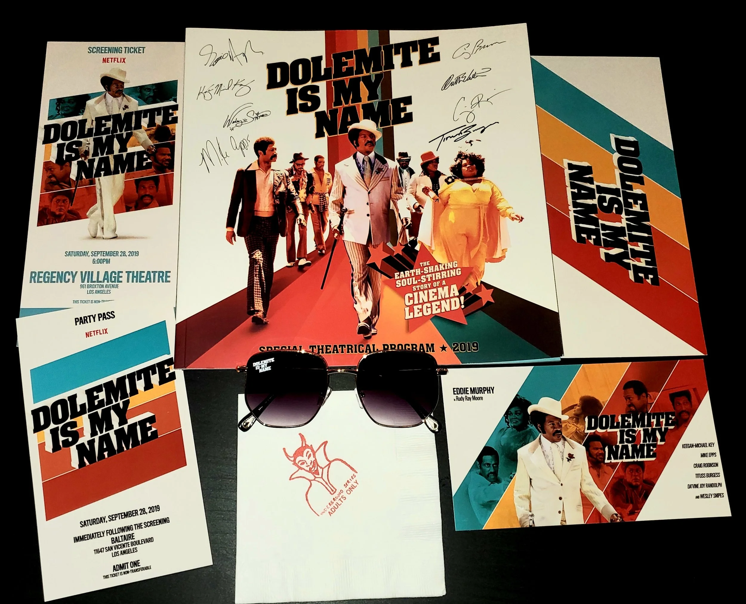Goodies from the event! A Special Theatrical Program discussing the movie and the legend of Rudy Ray Moore, film and after party passes, special “Dolemite is My Name” sun glasses and even special “underground series” napkins!