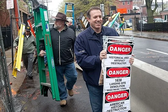 Historian Takes Construction Protest To New Level Greenberg and some supporters descended on the construction site at the corner of College and George Thursday afternoon armed with brightly colored stepladders. Perched atop the ladders, they held up letters forming a three-word sentence: “SAVE OUR HISTORY.” Greenberg has made that plea for weeks . Greenberg believes that the construction site—the $50 million future of home of new luxury apartments—is also the place where historic homes once stood, and their outhouses. Those ancient privies and garbage dumps are likely a motherlode of colonial artifacts, Greenberg said. Read the article in the New Haven Independent Historian Takes Construction Protest To New Level