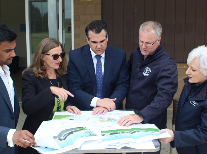 Club and government representatives reviewing facility plans