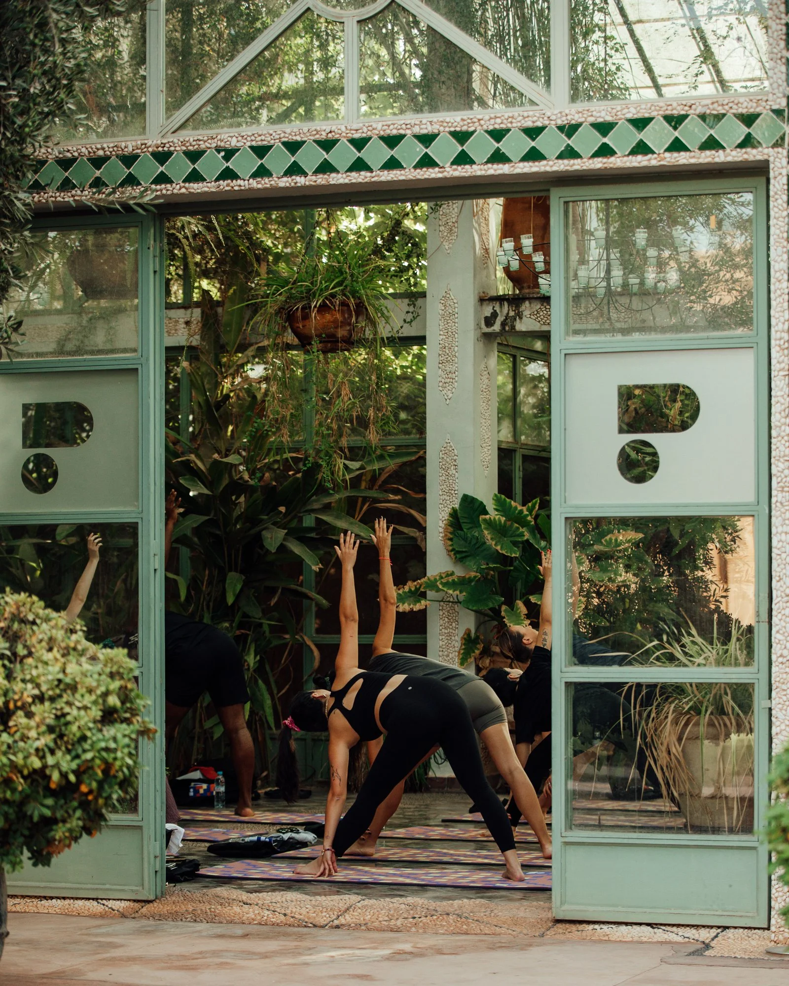  A carousel of images of PARADIGMS in Marrakesh showcasing the exterior entrance of the building during the day and illuminated at night. 