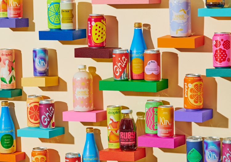  Colorful display of assorted functional drink cans and bottles arranged on vibrant shelves against a pastel background, featuring brands like Ghia, Kin, Sunwink, and Droplet. 