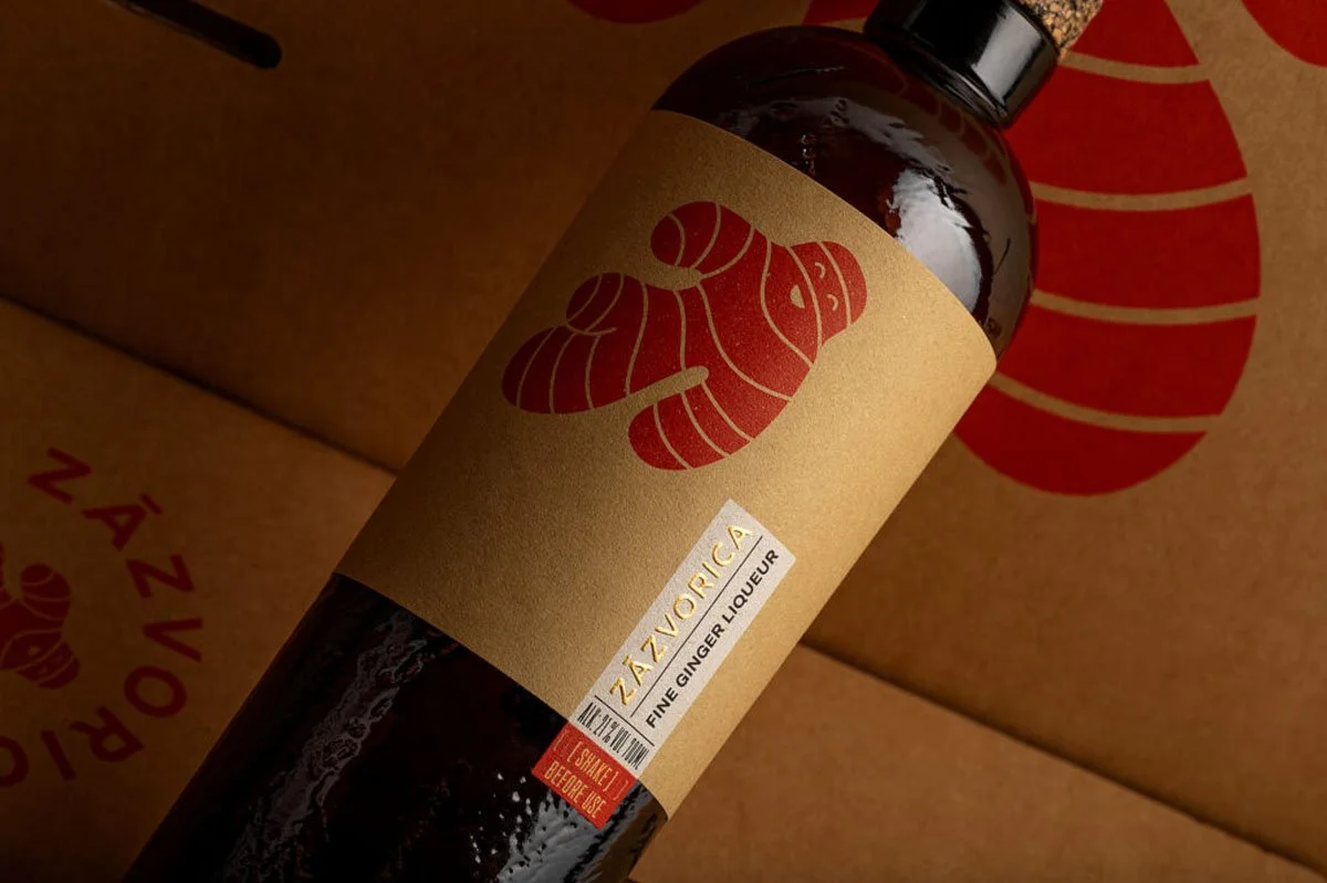  Close-up of a Zázvorica fine ginger liqueur bottle showcasing distinctive ginger root artwork and premium label design, set against branded packaging that reflects the spirit’s deep roots in Slovak culture and craftsmanship. 