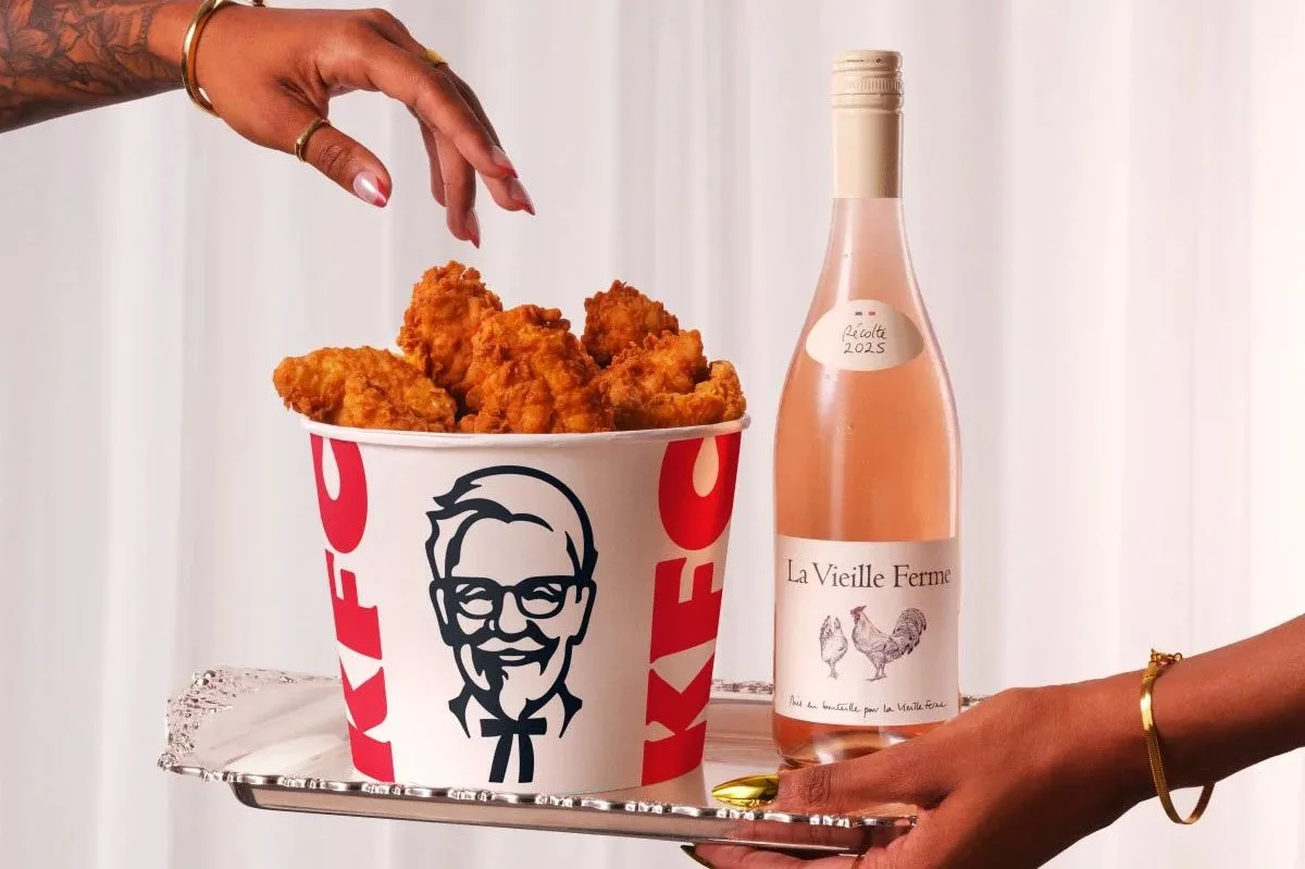 KFC x La Vieille Ferme partnership featuring KFC popcorn chicken and a glass of rosé wine against a soft pink backdrop.