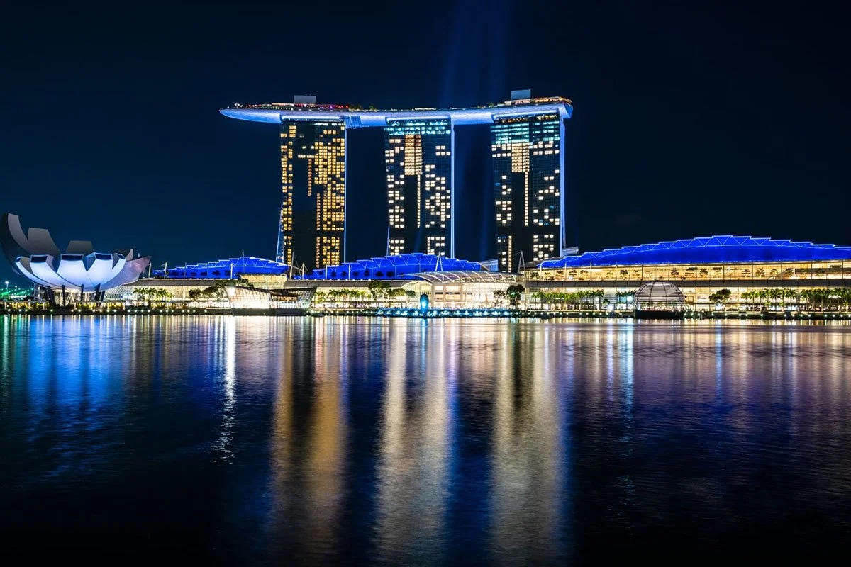 Marina Bay Sands illuminated at night during TFWA Asia Pacific 2026 in Singapore, with city skyline lights reflecting across the waterfront beside the ArtScience Museum and promenade.
