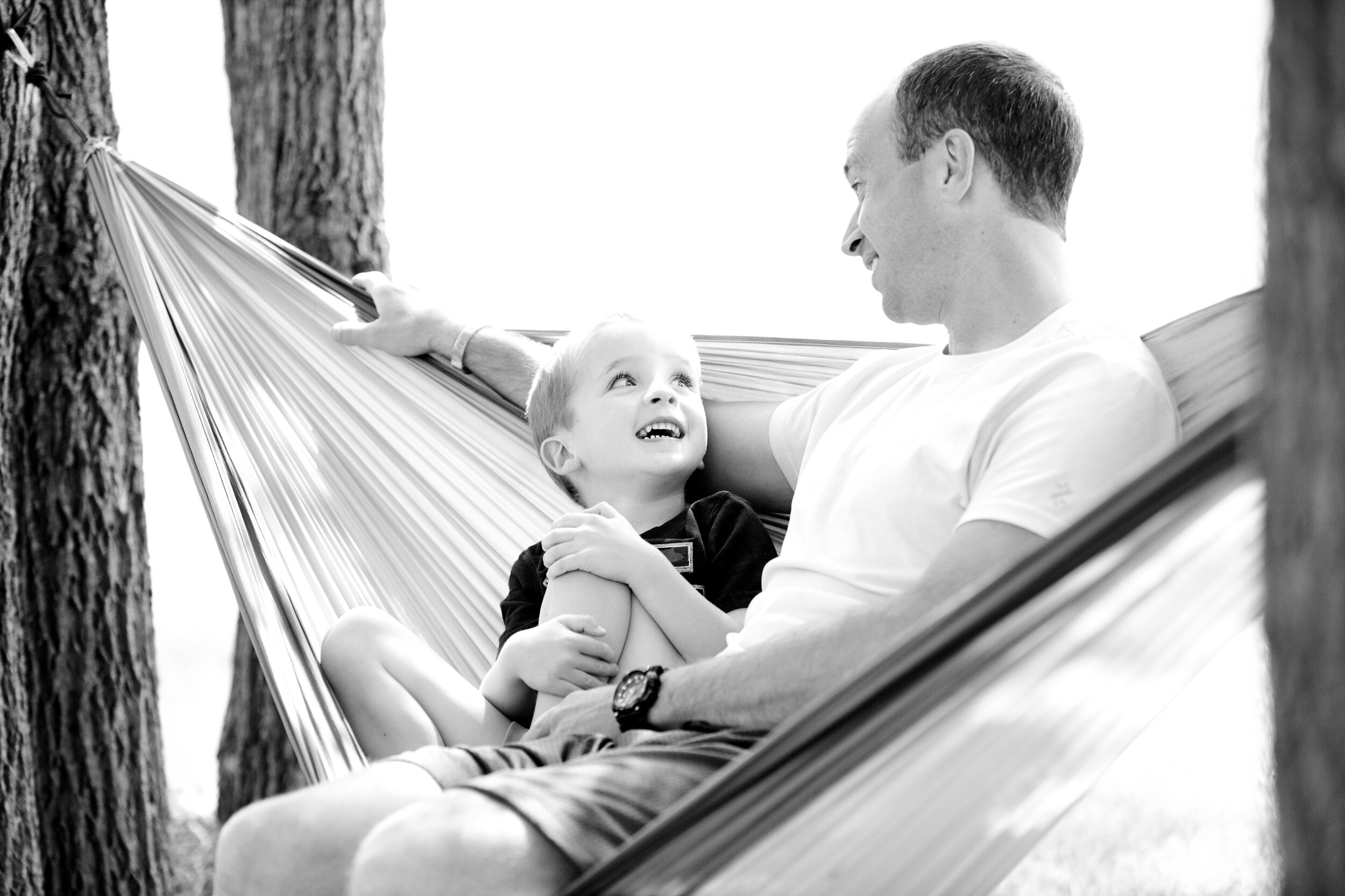 Canva - Grayscale Photo of Man and Child Sitting on Hammock.jpg