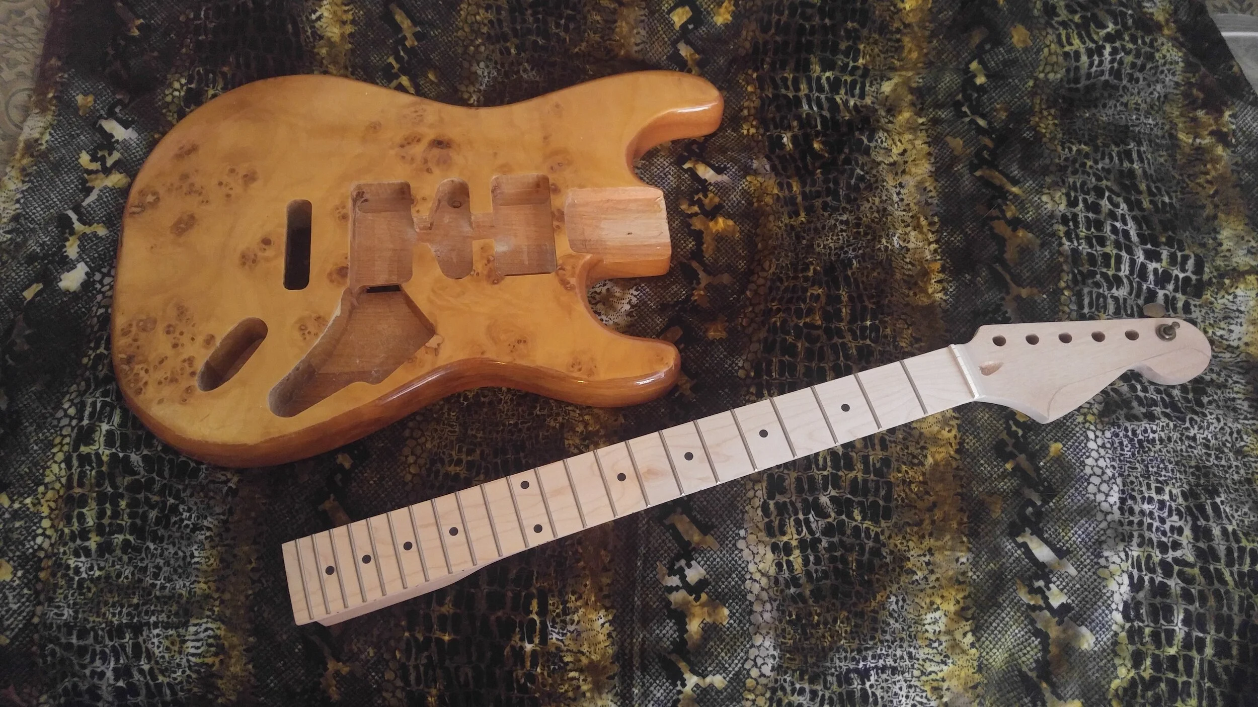 Tabula rasa.  Mahogany body blank, pre-routed with lacquer finish. And raw unfinished mahogany neck, with maple fingerboard.
