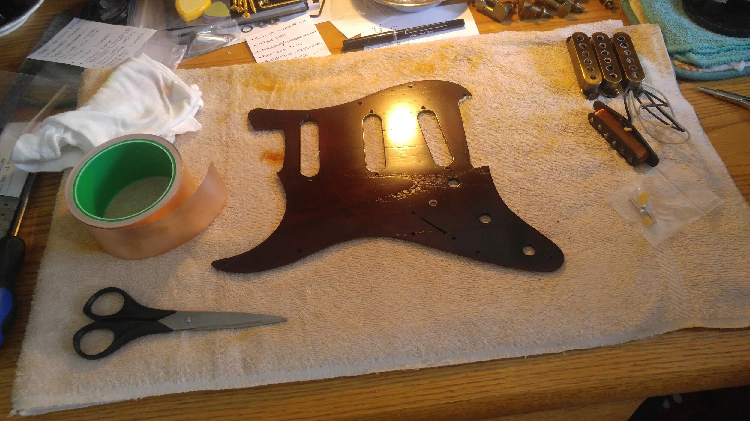 Preparing the pickguard for shielding tape.