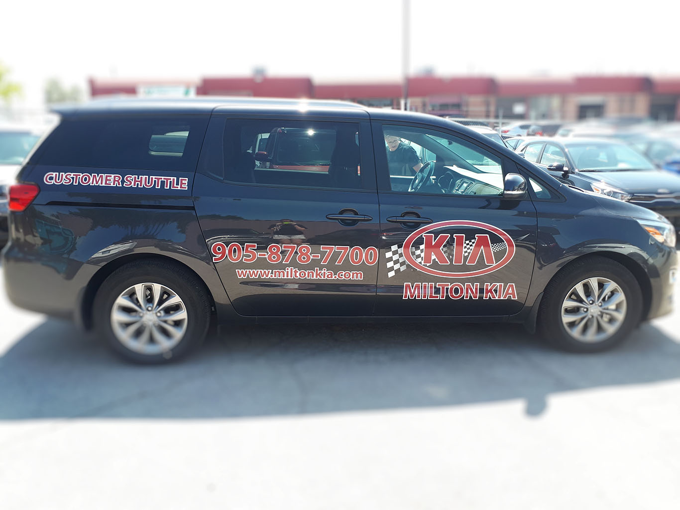 Miltown Signs courtesty shuttle graphics for KIA dealership.  The graphics are used for advertising the dealership while driving around the city.