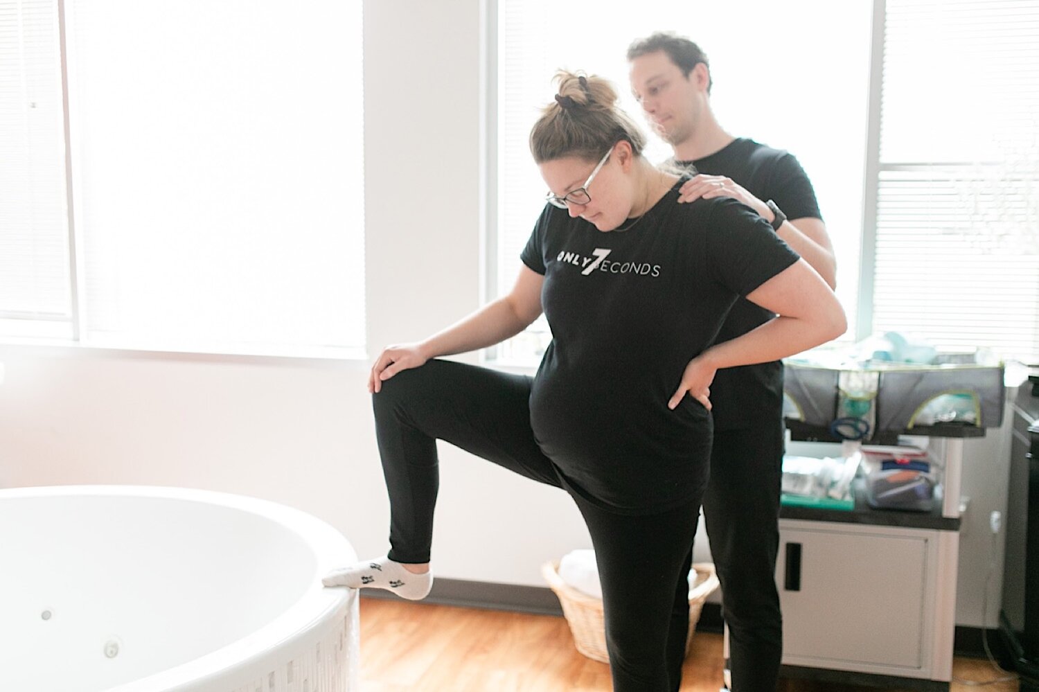 Justin making sure my shoulders stayed relaxed while I alternated lunging over the side of the tub to move baby lower.