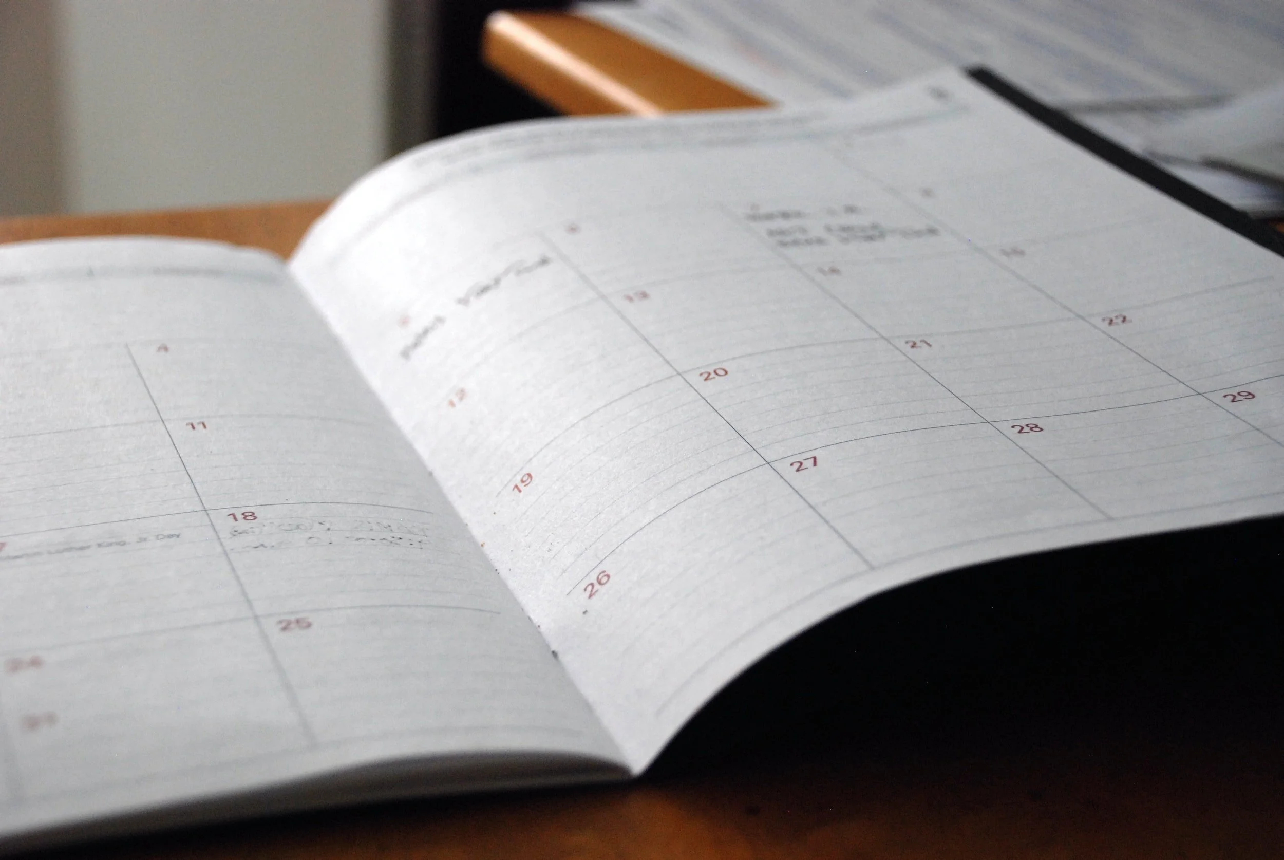 Open daily planner and appointment book, scheduling a personalized wealth management consultation with DDIMG Private Wealth Management