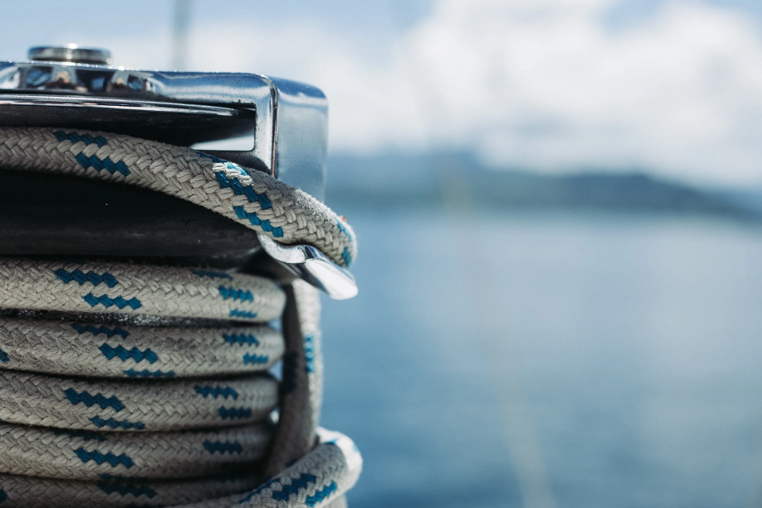Close-up of a coiled nautical winch rope on a sailboat, representing disciplined wealth management, risk management and financial planning by DDIMG