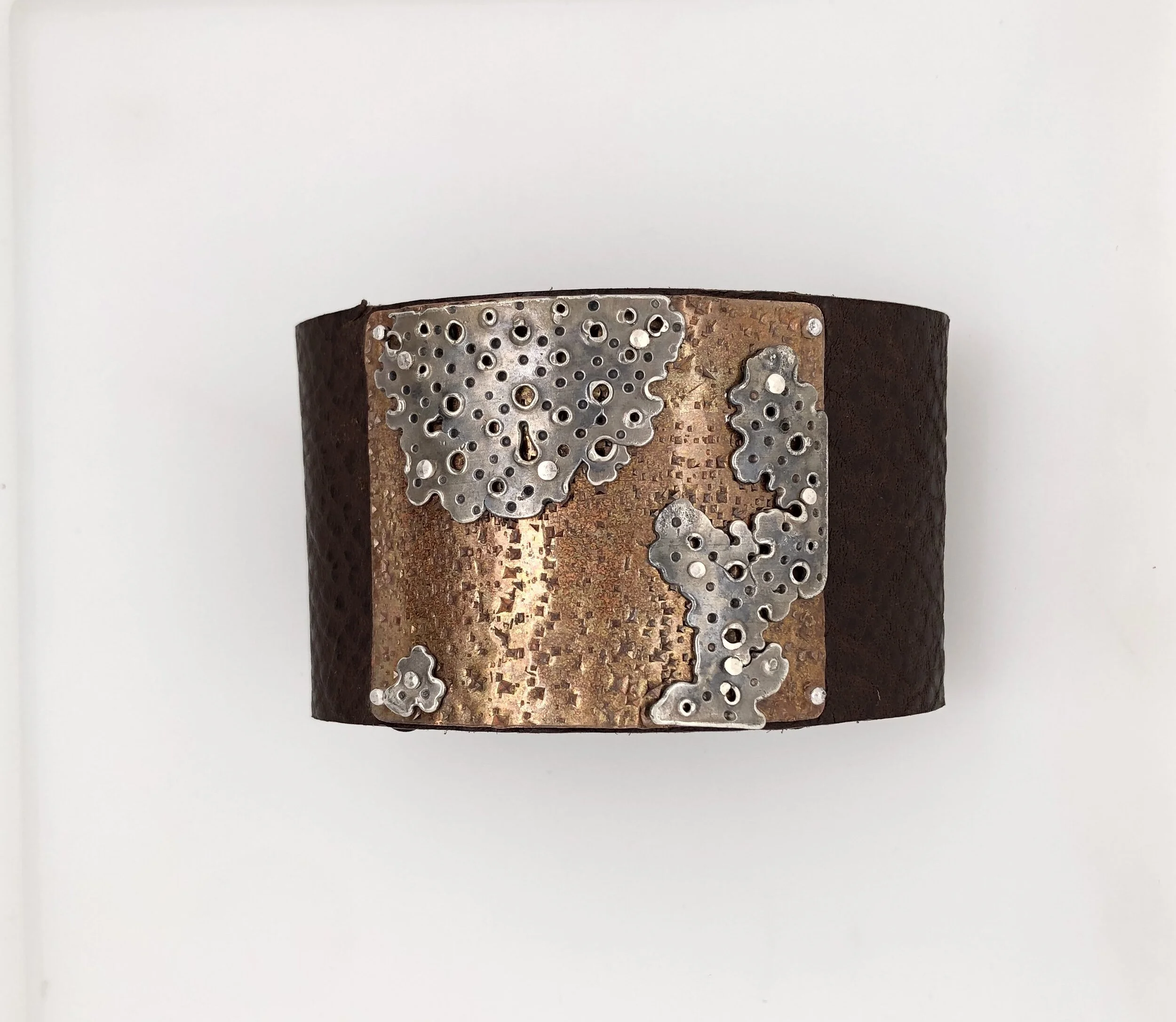  Cast sterling silver, copper and leather. 