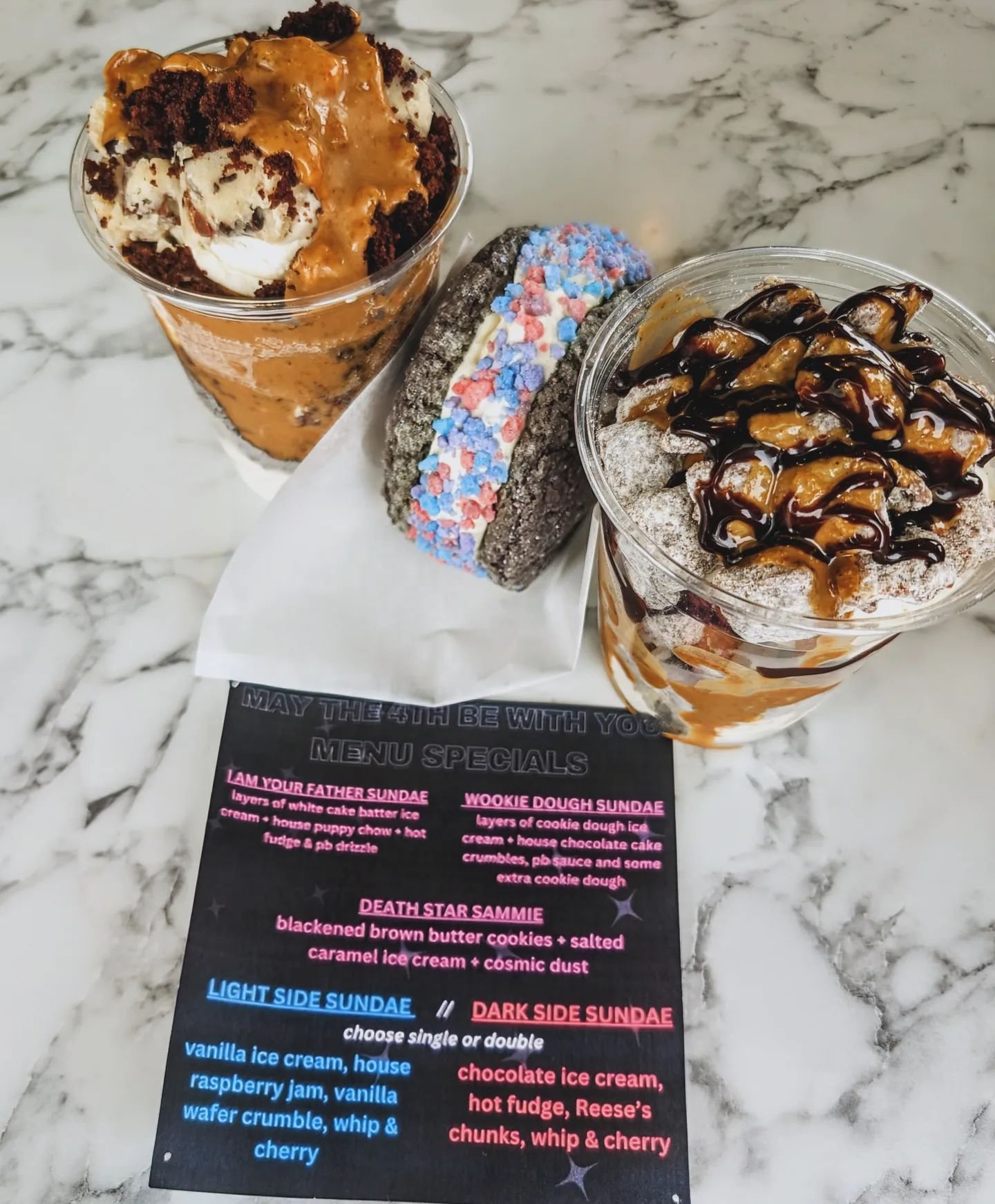 You know we weren't going to miss the chance to lean into a theme...
May the 4th Be With You menu is kicking off today!! So much peanut butter, so little time.

I AM YOUR FATHER SUNDAE
&bull; layers of white cake batter ice cream + house puppy chow +