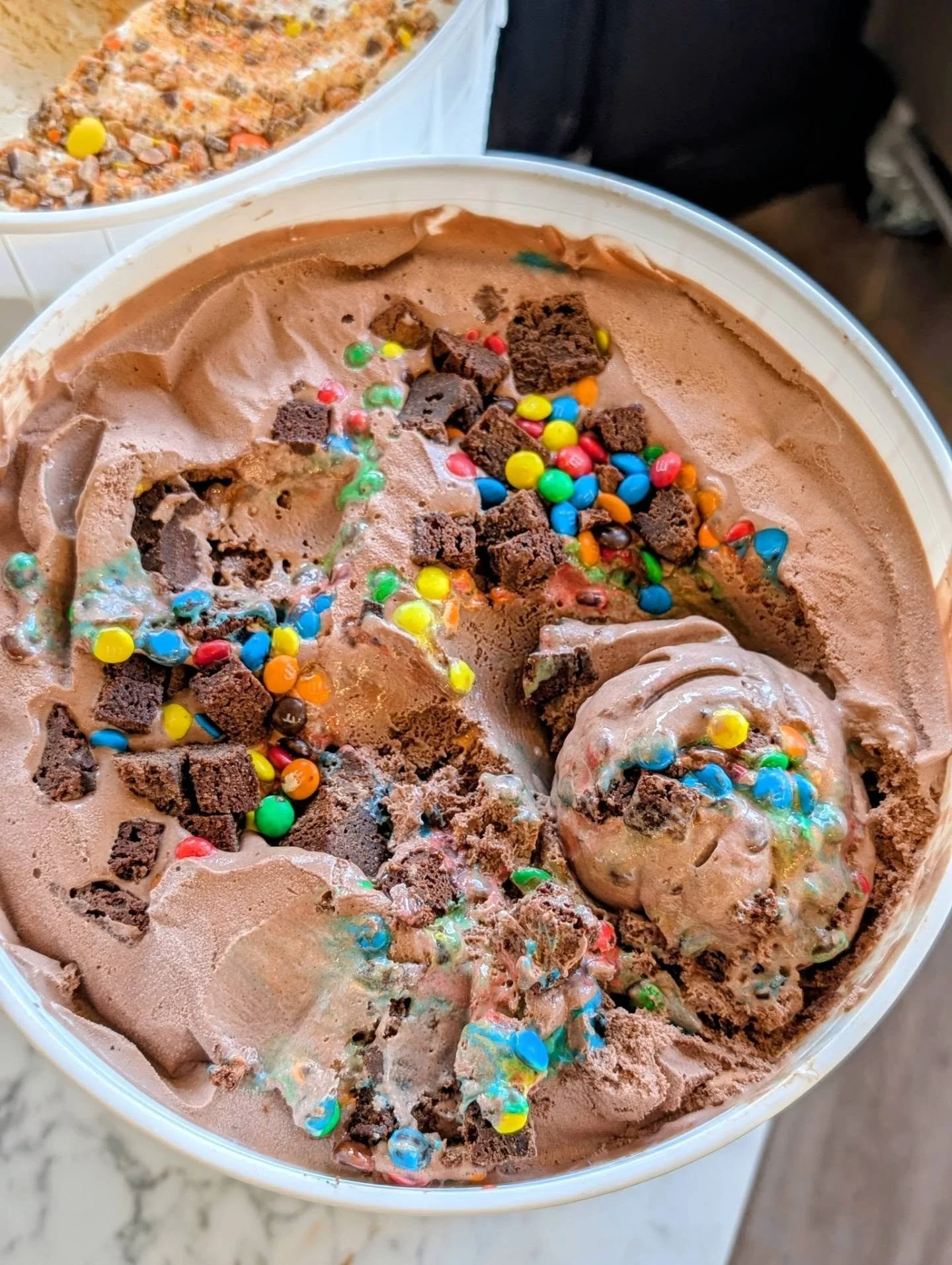 Happiness in a scoop.

CHOCOLATE M&amp;M BROWNIE
&bull; our rich chocolate ice cream made with 100% brute cocoa powder + house triple chocolate brownie chunks &amp; mini m&amp;ms &bull;

And I know y'all so well, that I know you're going to put peanu