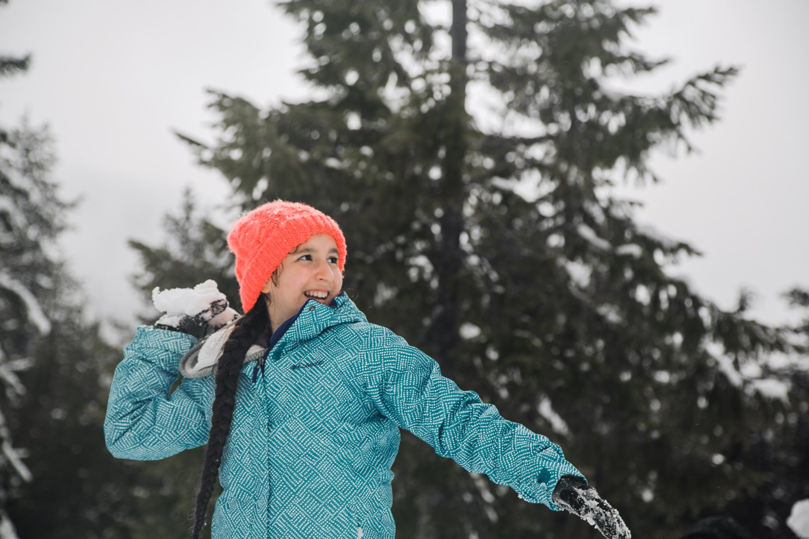 AWL-Year_End-Snowshoeing_Girl_Throwing_Snownall.jpg