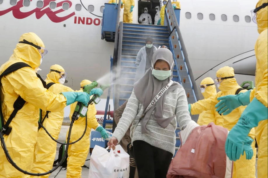 Coronavirus evacuees sprayed with DISINFECTANT as they arrive at quarantine in Indonesia from Wuhan