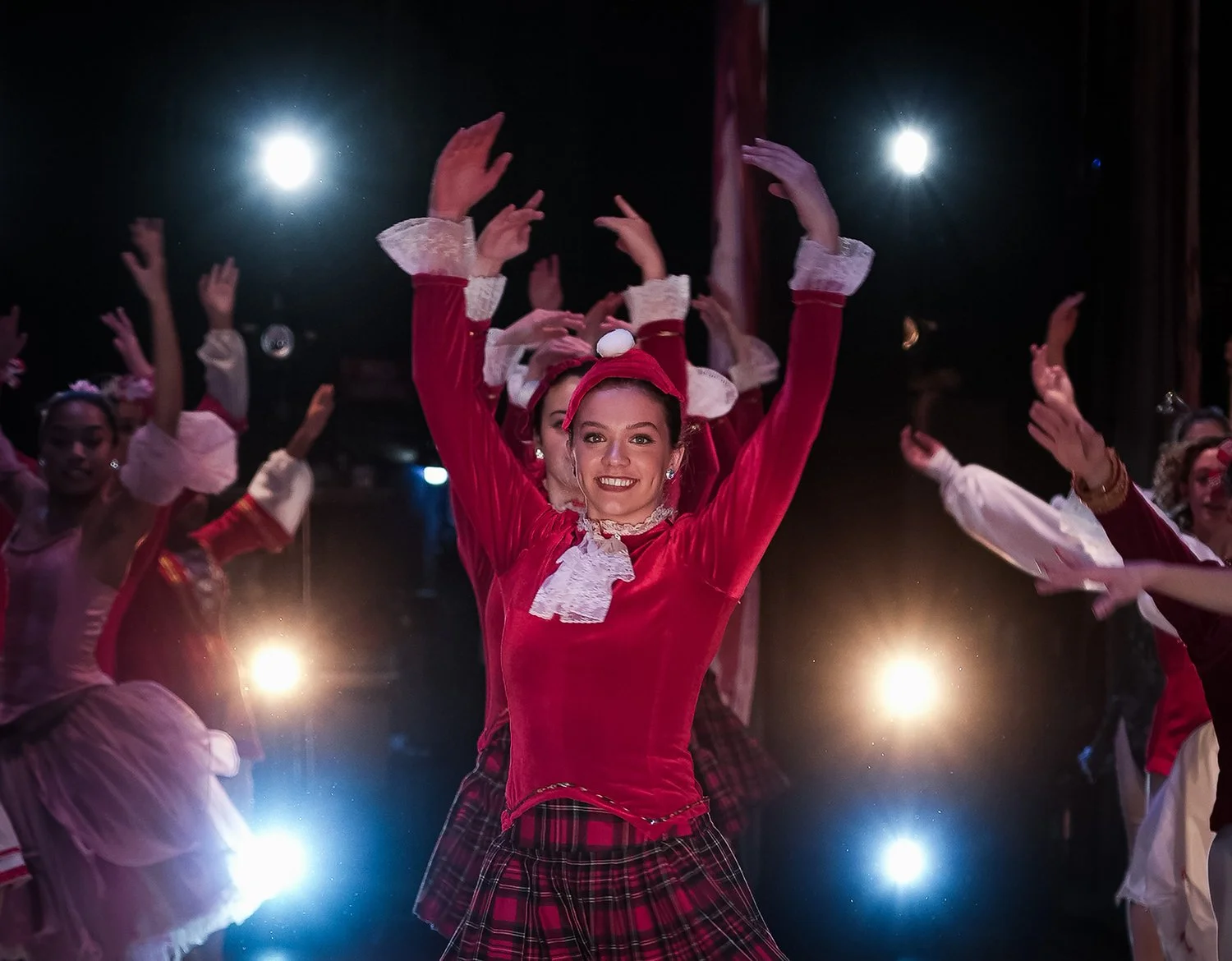 Dancer with arms raised above her head