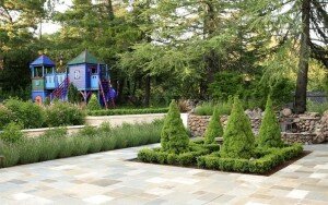 A blue play structure for a green space