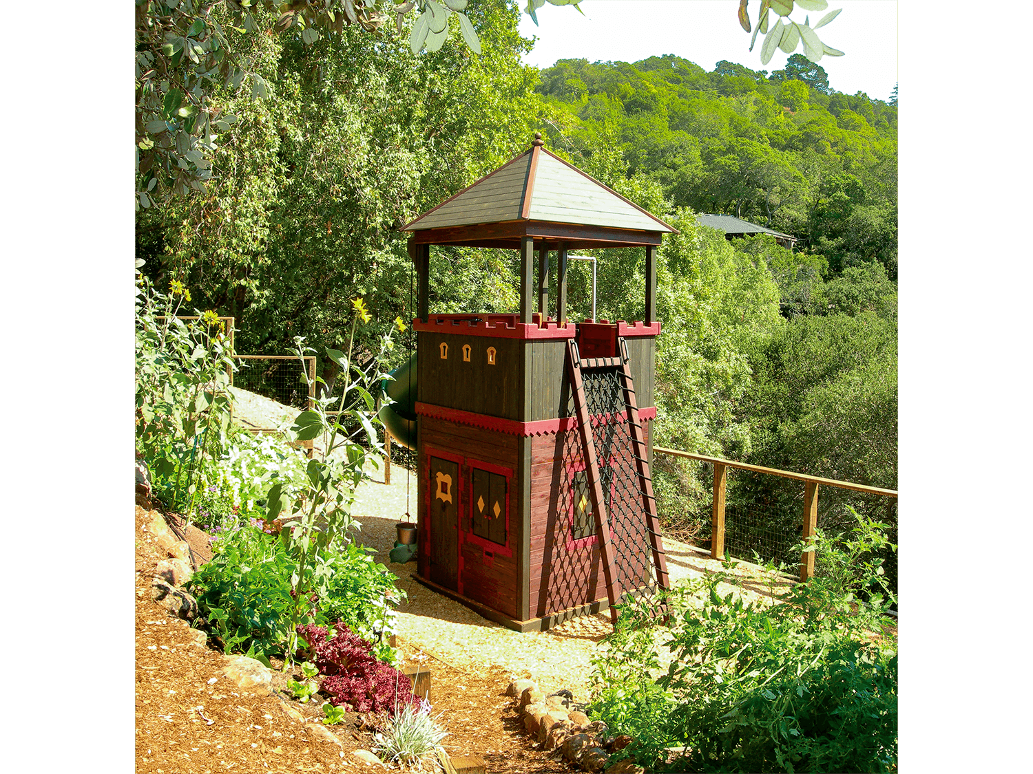  The Fortress is a small-but-mighty two-story play space with a roofed deck area above and a playhouse below. 