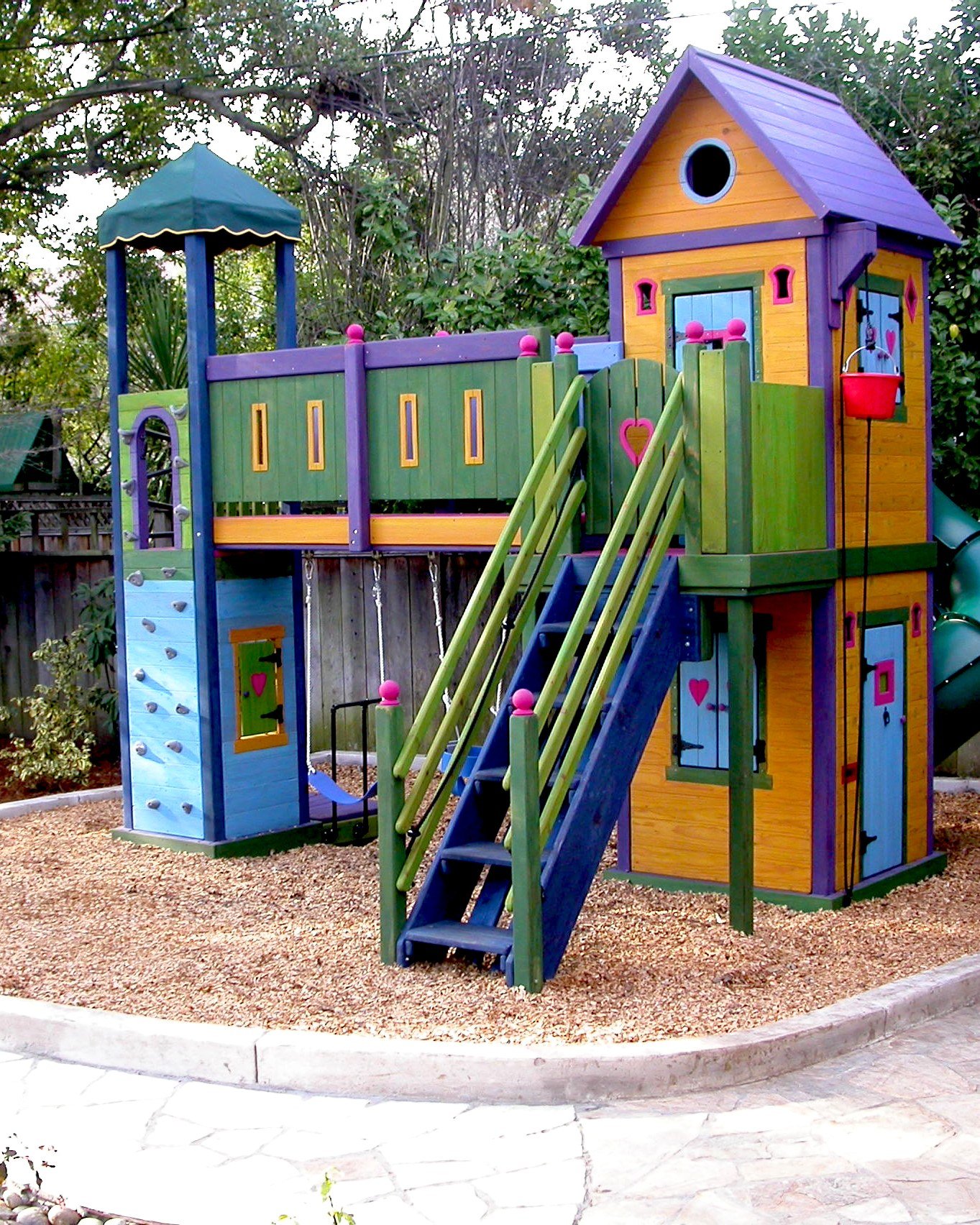 A dash of gingerbread, a pinch of wizard, and a dusting of castle went into this two-story fort playhouse. Compact, but packed with play accessories such as a rock wall, crazy bar climb, earthquake platform, turbo slide and bucket pulley, you get a l