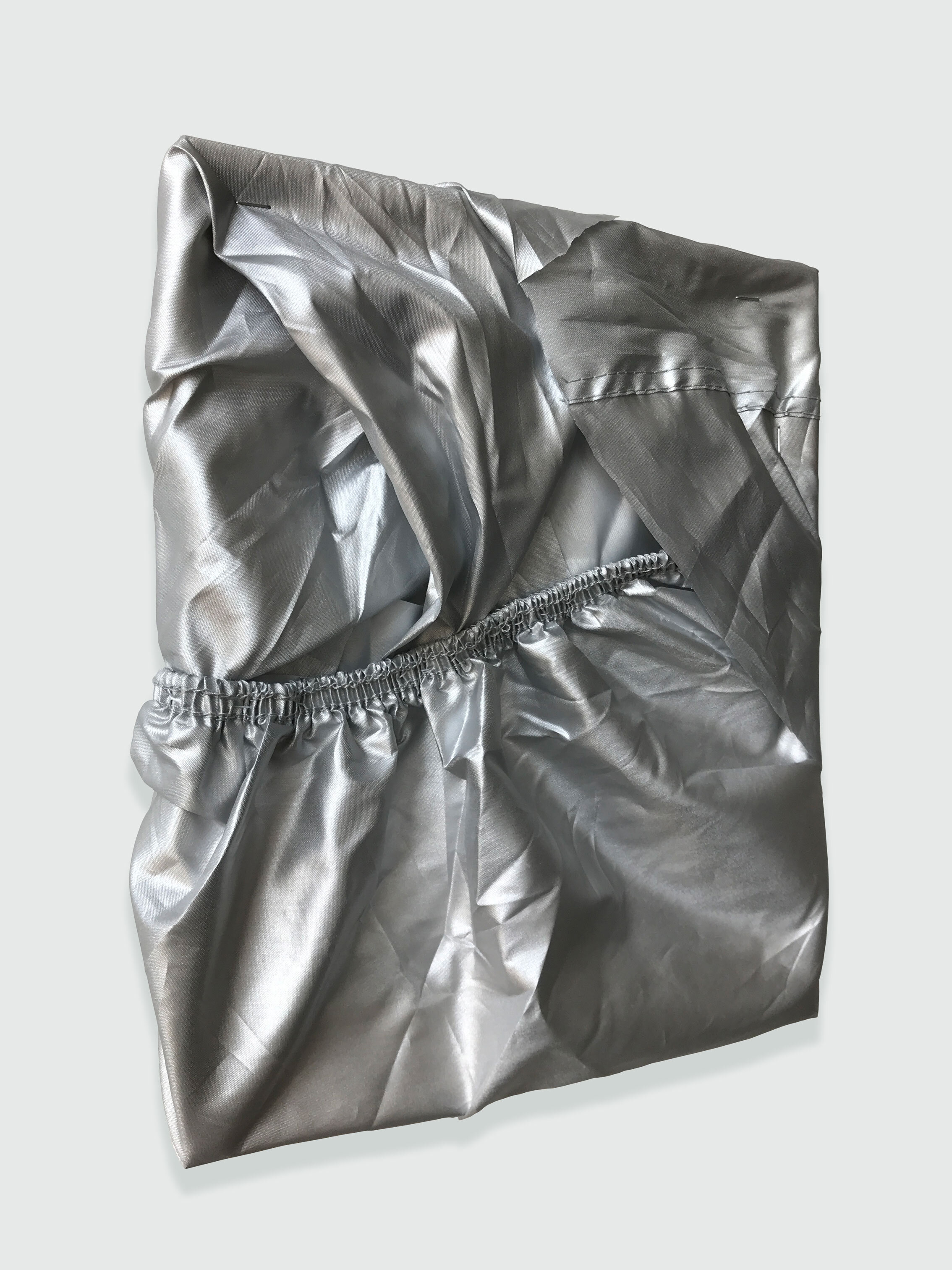 Laura Hunt,  Untitled , 2019 (side view), metallic motorcycle cover, 12 x 10 inches (edges variable). 