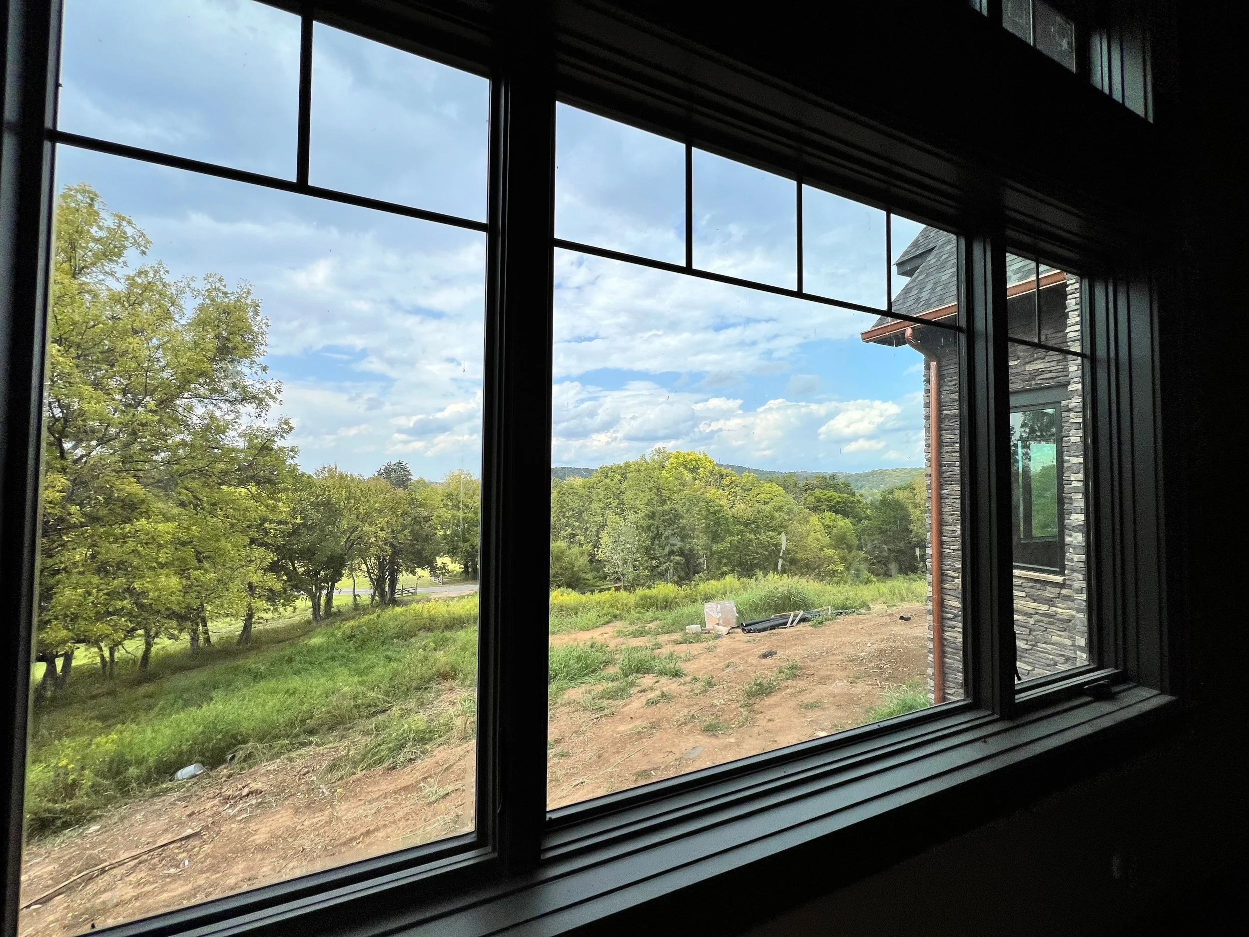 A view of a rural landscape from inside the kitchen window during a landscape design consultation