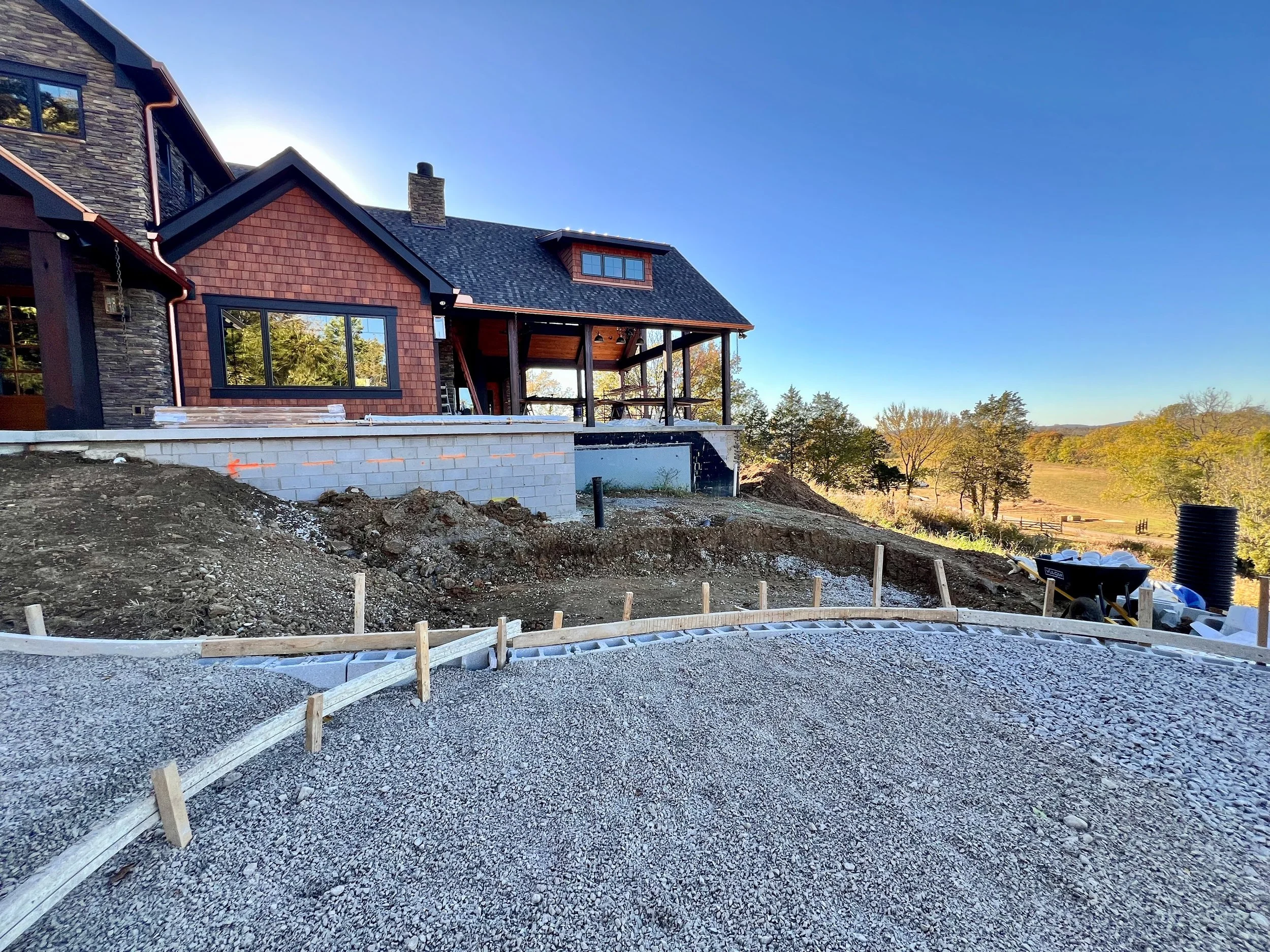 A residential outdoor patio in construction on a Middle TN property designed by The Grass Girl