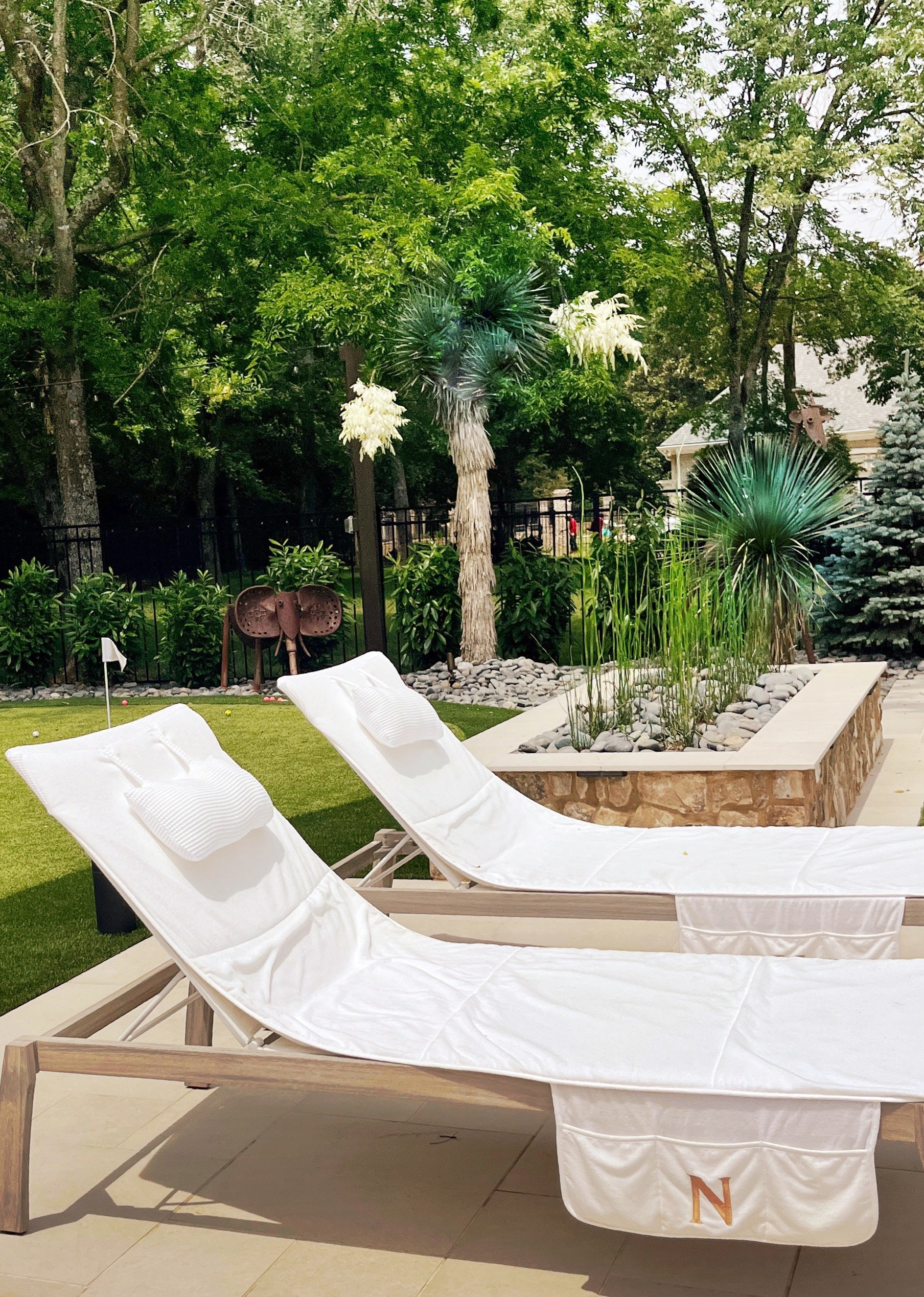 A Franklin, TN back yard retreat poolside with mature yuccas and garden statuary