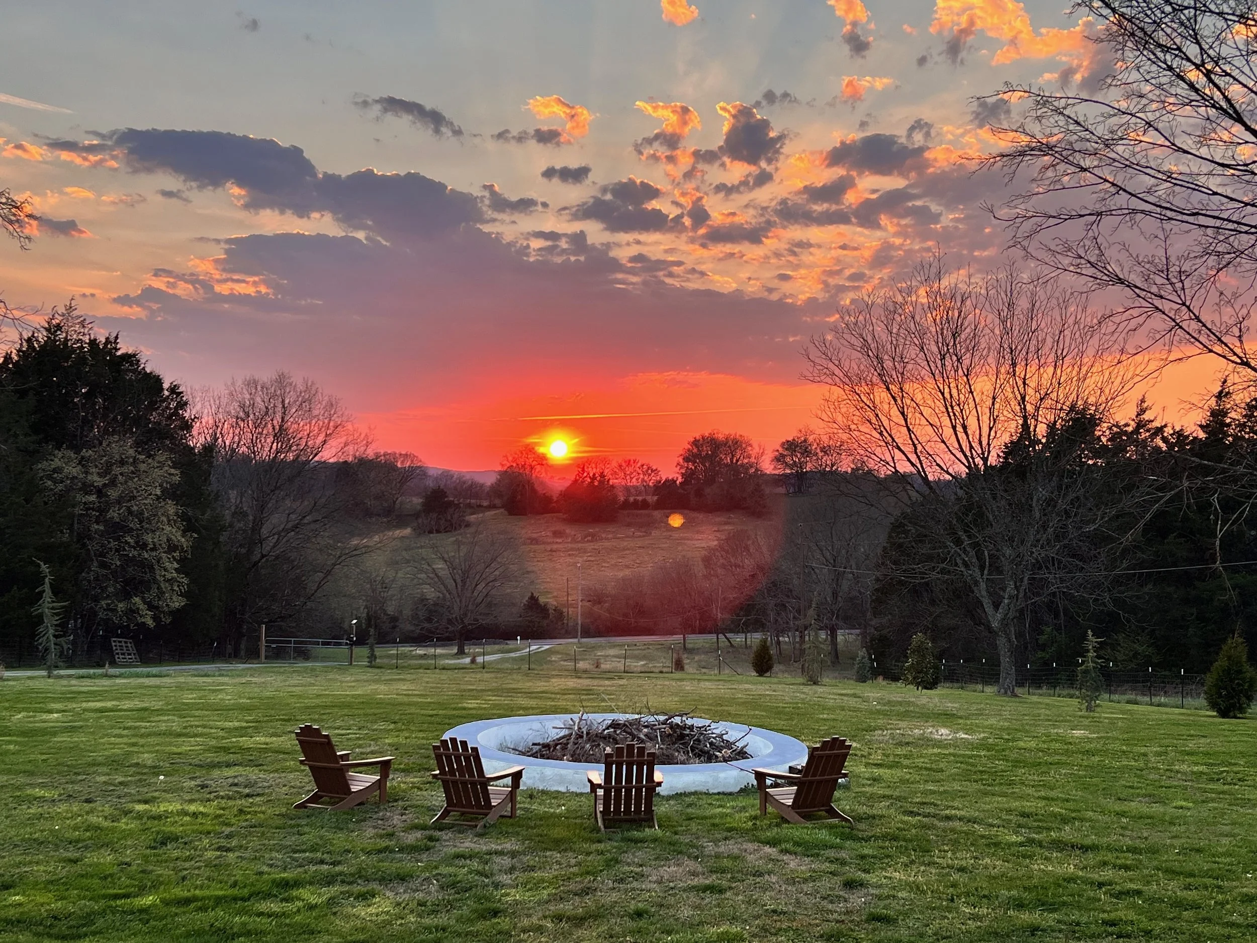 Pink sky sunset overlooking farm hills in rural Tennessee land
