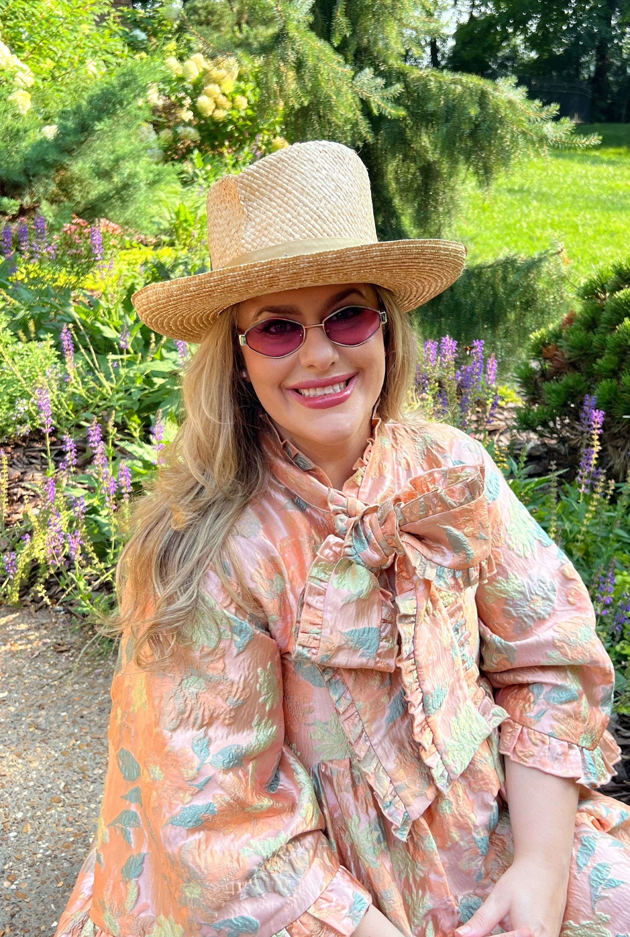 Clare Horne, founder of The Grass Girl and garden landscape designer serving Nashville and Middle Tennessee, in a designed garden.