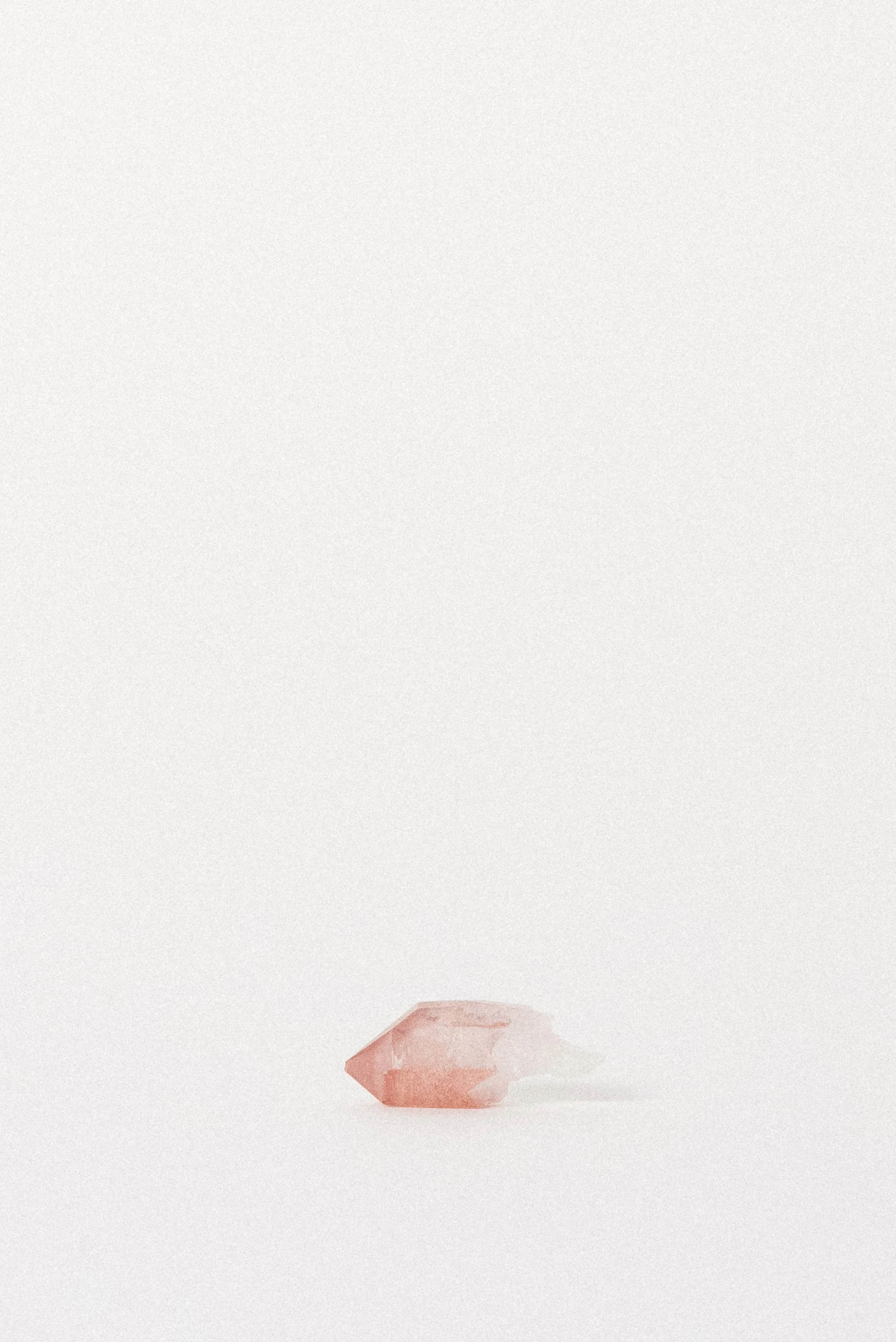 Small Hematite-included Pink Quartz crystal from Bharatpur, Rajasthan, showing soft rose-to-clear gradient.