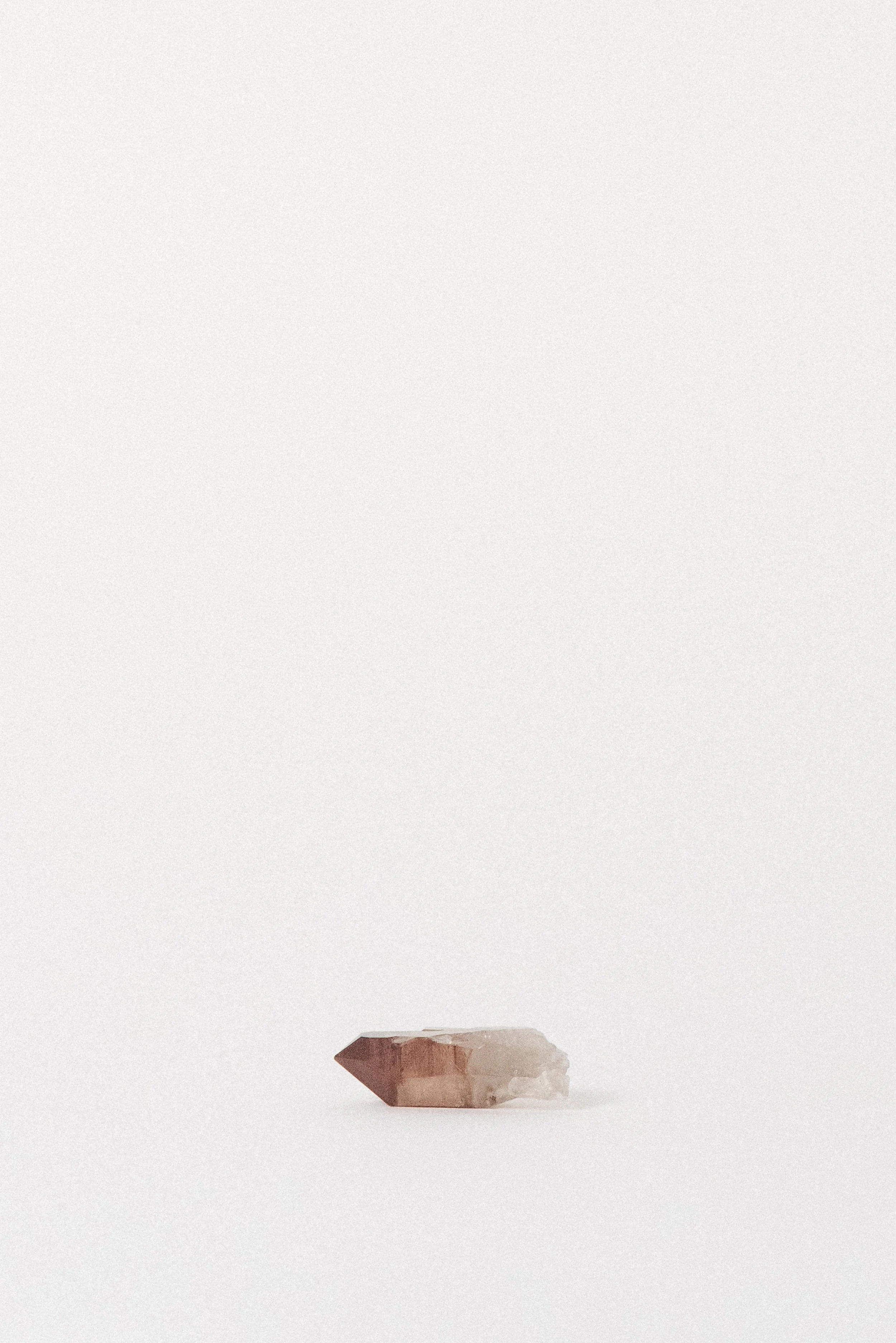 Grounded view of ferruginous Quartz with dark red phantom tip.