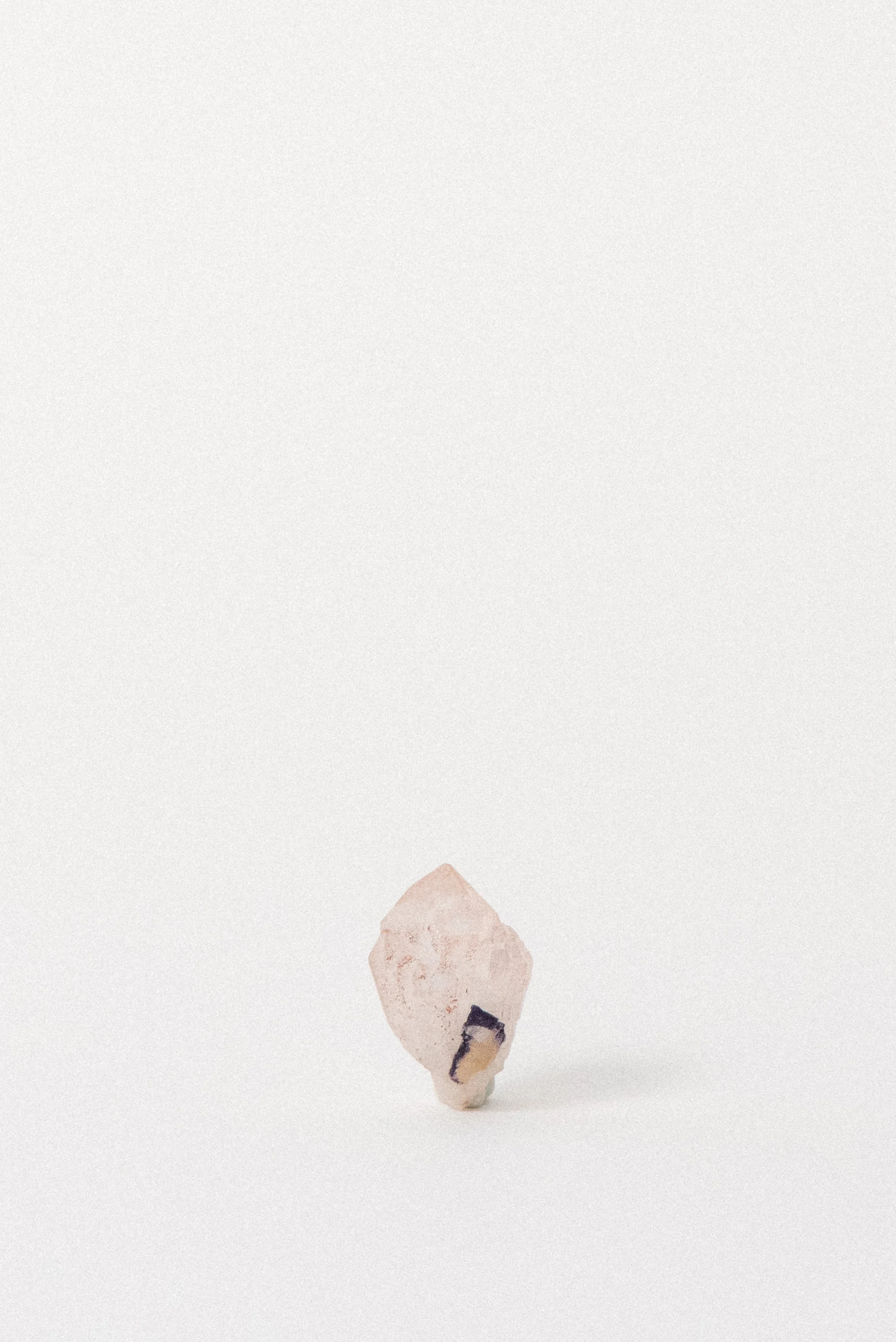 Upright Pink Quartz point from Kishangarh, Rajasthan, India, with hematite and fluorite inclusion