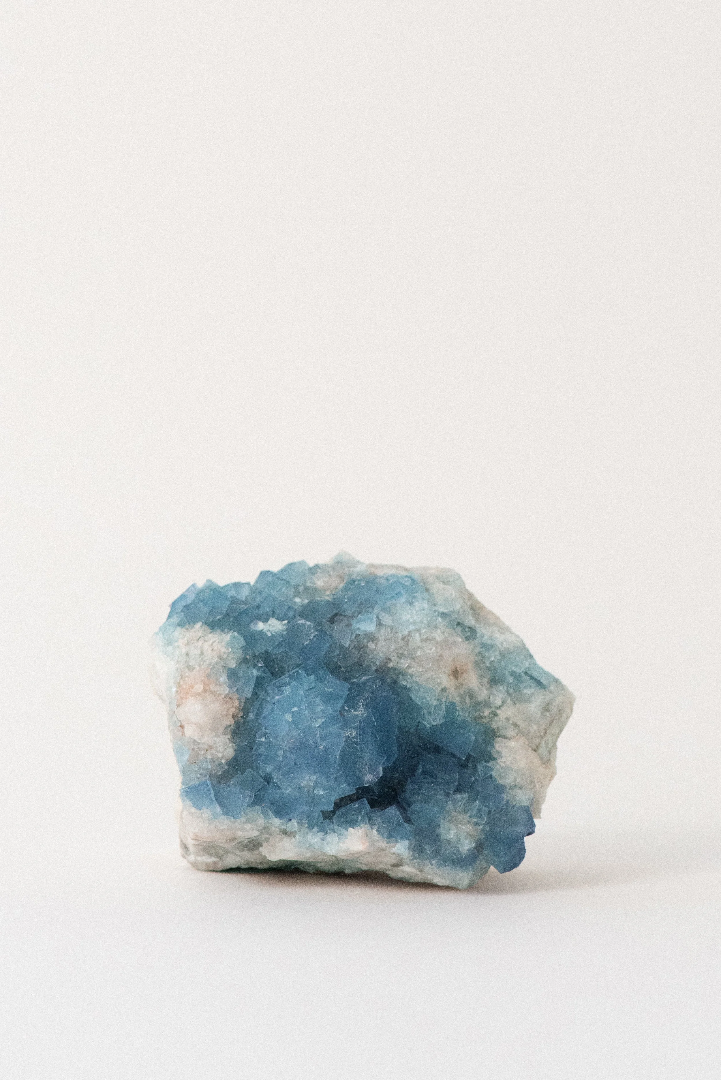 Blue fluorite cluster on matrix from Blanchard Mine, Hansonburg District, Socorro County, New Mexico. Fluorescent and highly saturated specimen offered by Crystal Voyager.