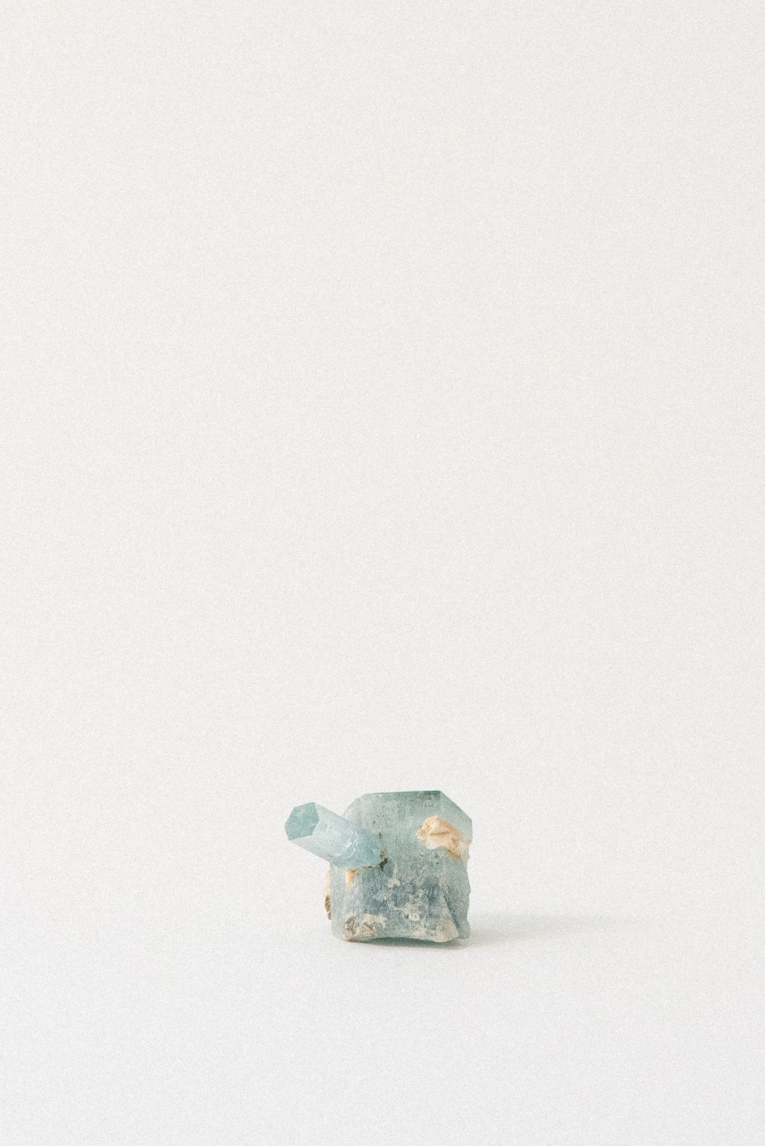 Aquamarine crystal with prominent point from Erongo Mountain, Namibia, photographed on a white surface