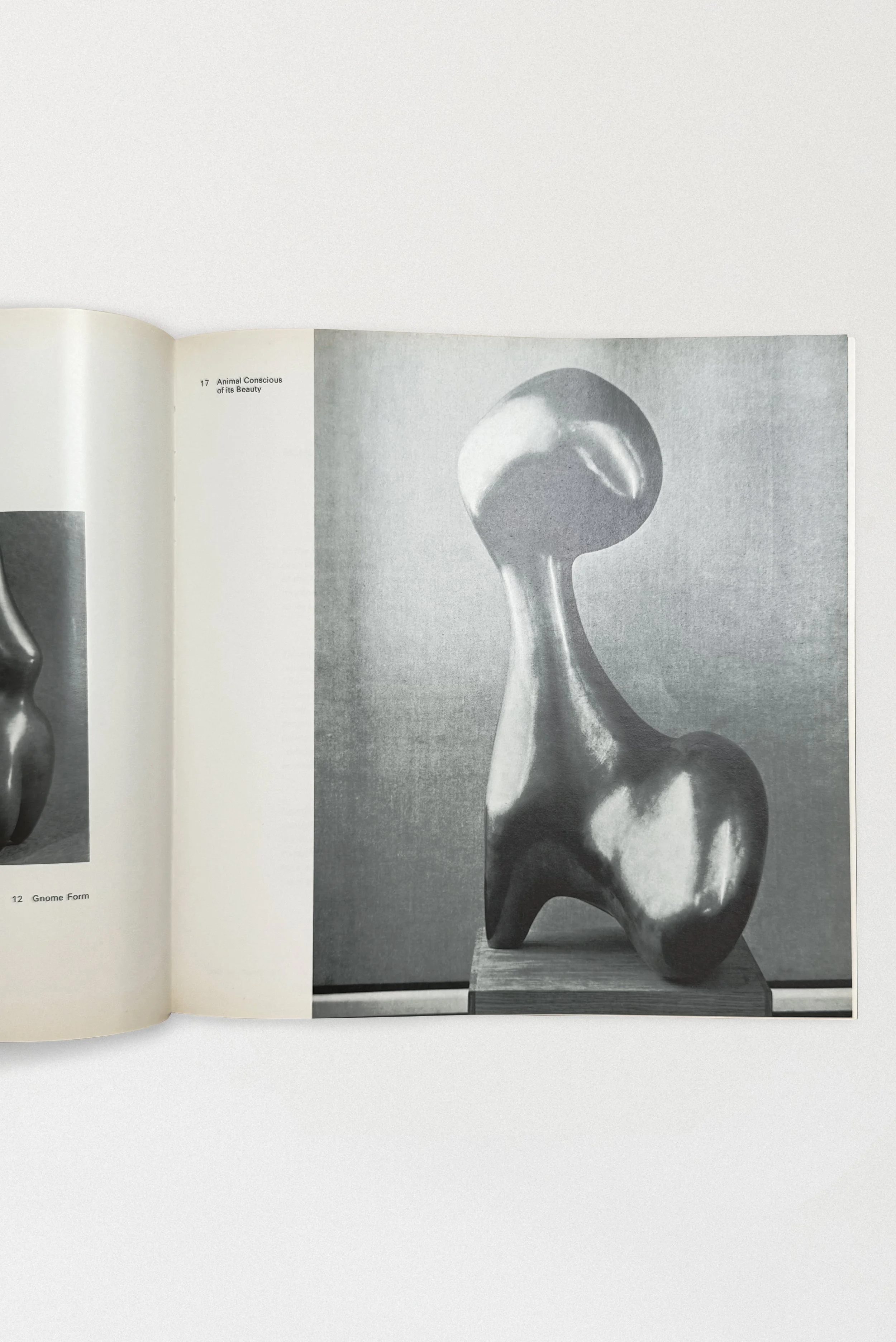Interior spread from Jean Arp: Sculpture, Reliefs, Works on Paper (1975), featuring a full-page black-and-white photograph of the bronze sculpture Animal Conscious of Its Beauty.